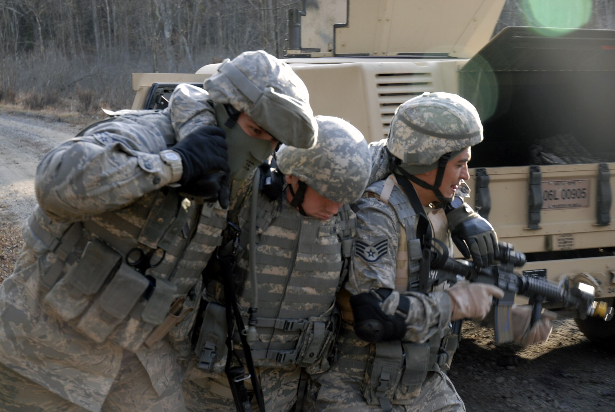 Students in the U.S. Air Force Expeditionary Center's Phoenix Warrior Training Course move an "injured Airman" while taking cover during a scenario for convoy operations training in the course Dec. 5, 2008, on a Fort Dix, N.J., range.  The course is taught by the Center's 421st Combat Training Squadron and prepares security forces Airmen for upcoming deployments. (U.S. Air Force Photo/Staff Sgt. Paul R. Evans)