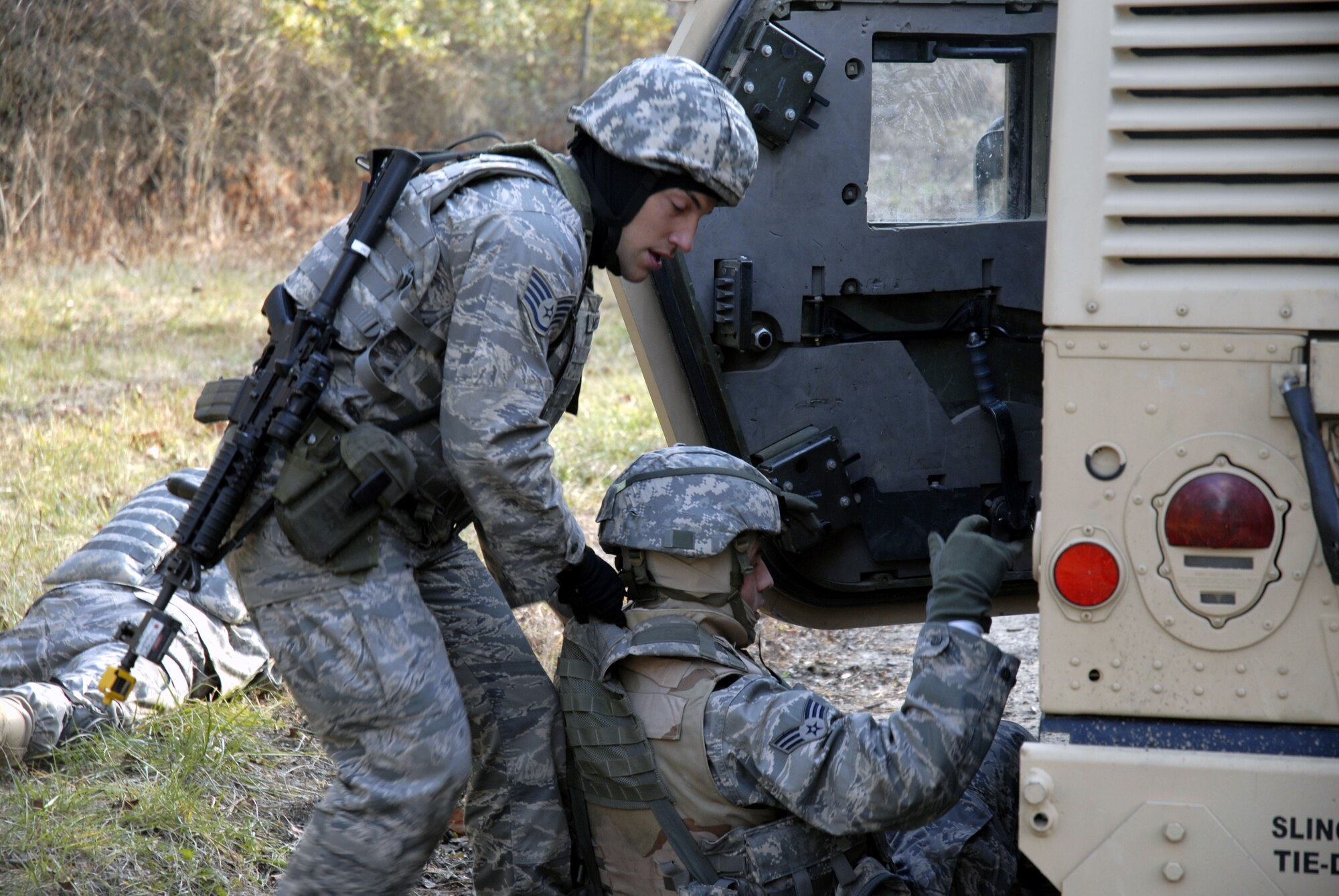 A student in the U.S. Air Force Expeditionary Center's Phoenix Warrior Training Course moves an "injured Airman" while taking cover during a scenario for convoy operations training in the course Dec. 5, 2008, on a Fort Dix, N.J., range.  The course is taught by the Center's 421st Combat Training Squadron and prepares security forces Airmen for upcoming deployments. (U.S. Air Force Photo/Staff Sgt. Paul R. Evans)