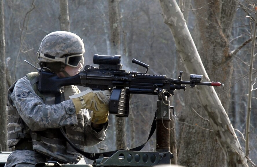 A student in the U.S. Air Force Expeditionary Center's Phoenix Warrior Training Course fires his machine gun during a scenario for convoy operations training in the course Dec. 5, 2008, on a Fort Dix, N.J., range.  The course is taught by the Center's 421st Combat Training Squadron and prepares security forces Airmen for upcoming deployments. (U.S. Air Force Photo/Staff Sgt. Paul R. Evans)
