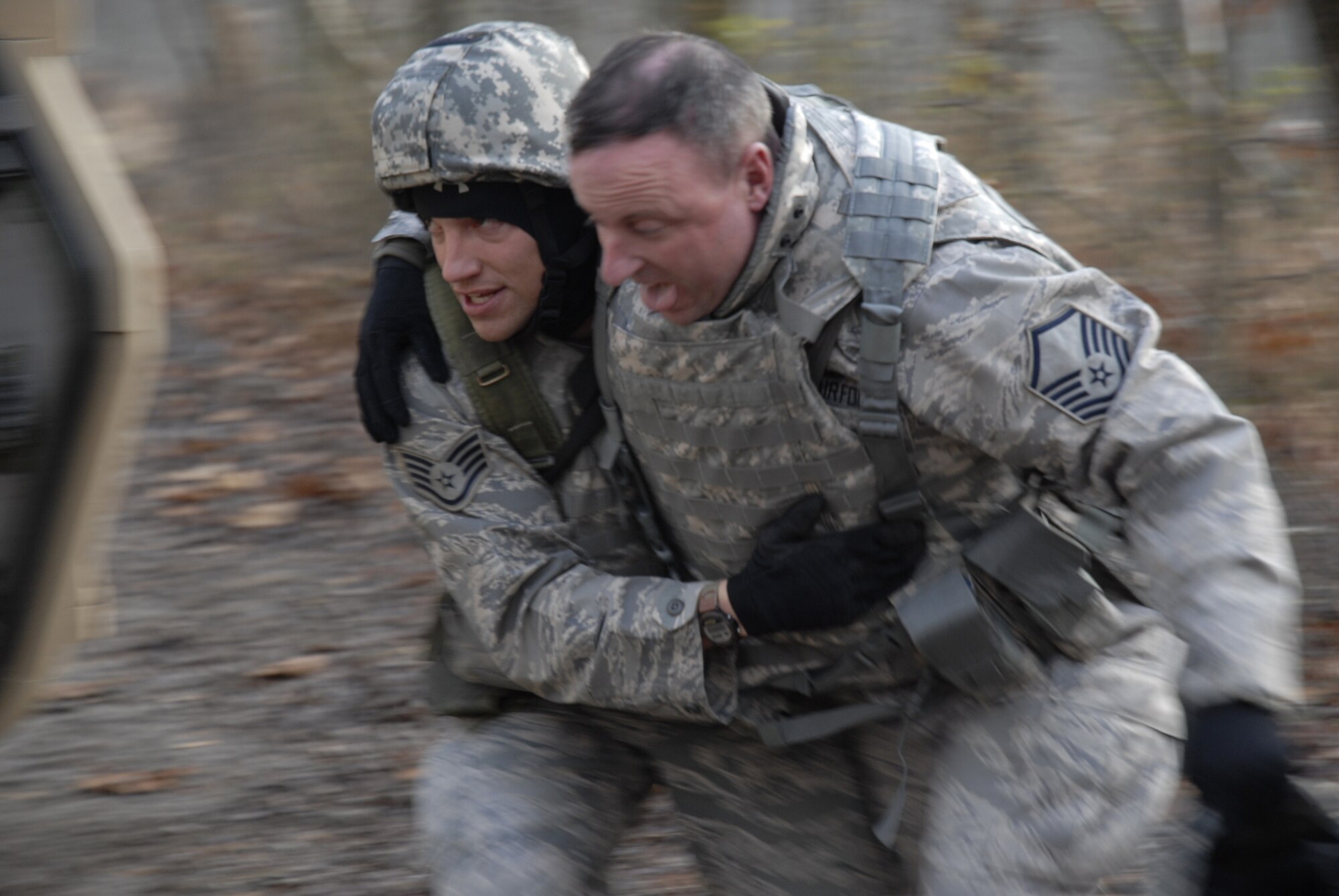 A student in the U.S. Air Force Expeditionary Center's Phoenix Warrior Training Course moves an "injured Airman" during a scenario for convoy operations training in the course Dec. 5, 2008, on a Fort Dix, N.J., range.  The course is taught by the Center's 421st Combat Training Squadron and prepares security forces Airmen for upcoming deployments. (U.S. Air Force Photo/Staff Sgt. Paul R. Evans)