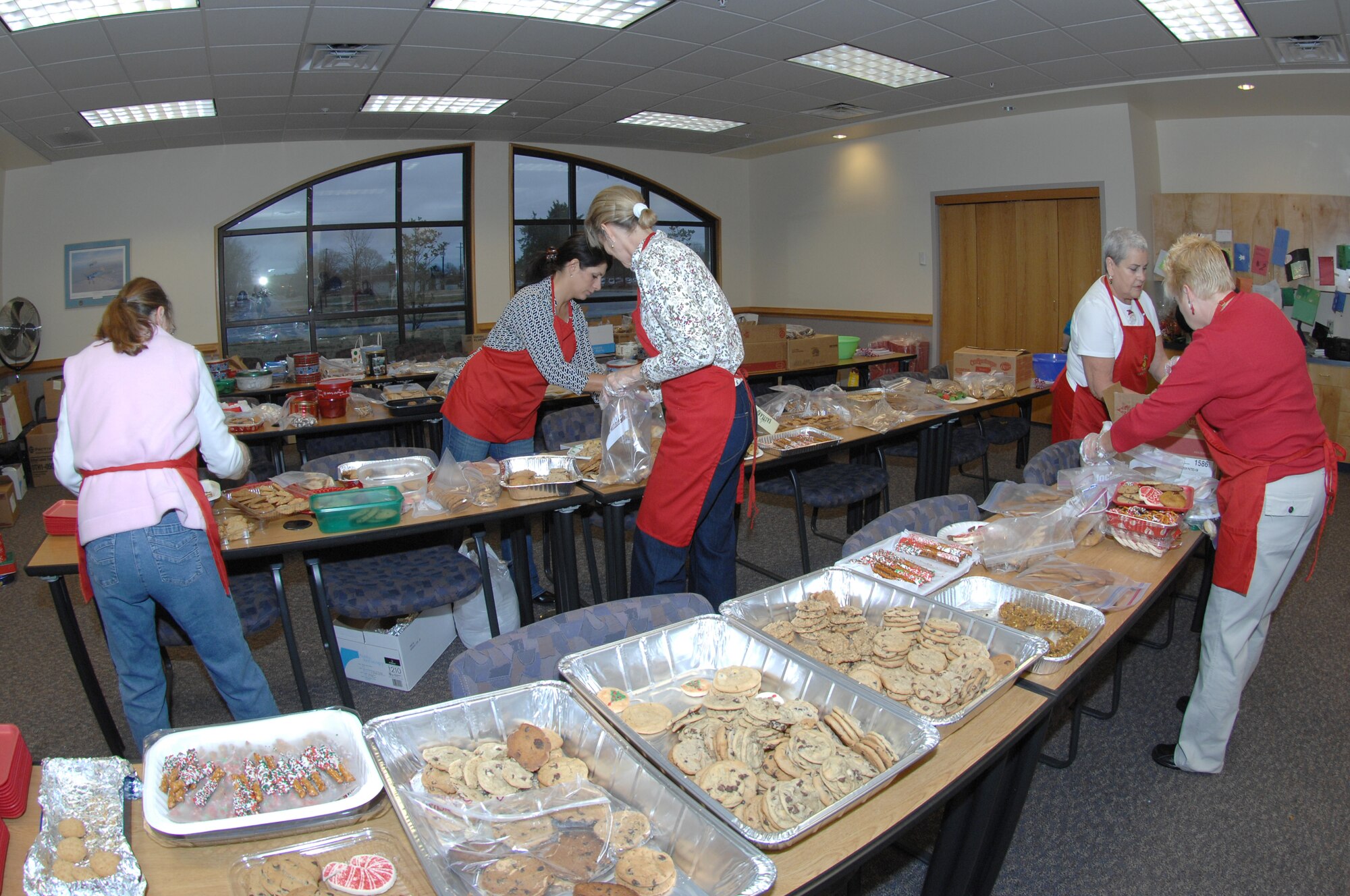 LANGLEY AIR FORCE BASE, Va. – Members of the Langley Officers' Spouses’ Club prepare approximately 2,000 dozen cookies to distribute Dec. 12 to 826 dormitory residences, other base personnel, and off-base agencies to include United Service Organizations. The cookie drive is an Air Force tradition to bring joy to young Airmen who spend the holidays away from home. (U.S. Air Force photo/Tech. Sgt. April Wickes)   