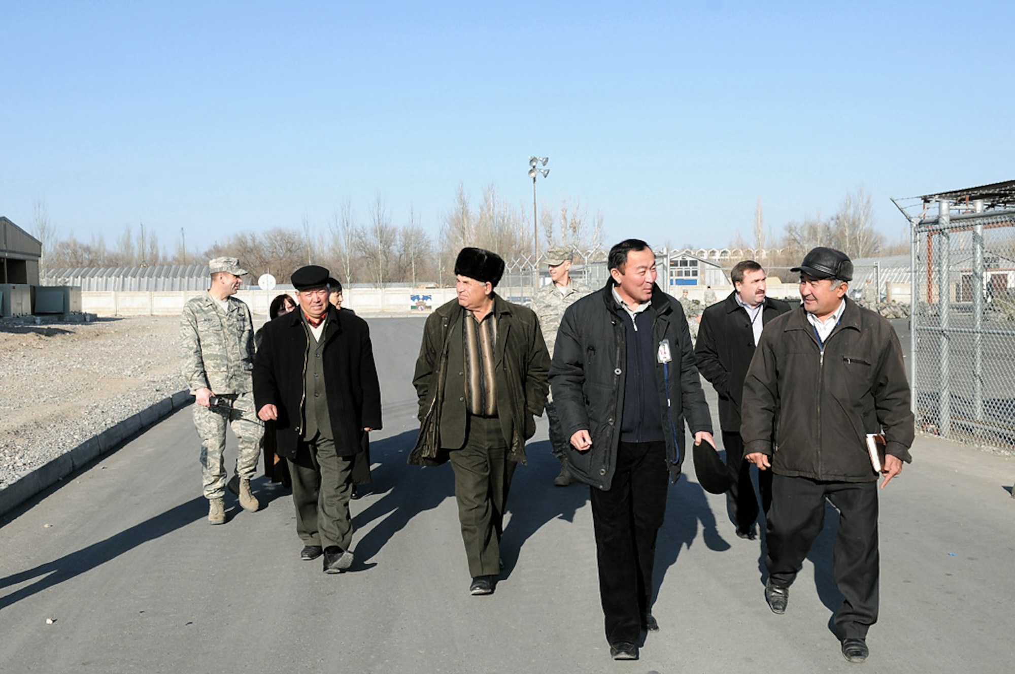 Col. Christopher Bence talks with Kyrgyz village mayors and their deputies as he leads them on a Dec. 10 tour of Manas Air Base, Kyrgyzstan. Leaders from six villages around Manas AB visited the base and had lunch with wing leaders. The visit strengthened friendships and issues affecting the local villages that the base can assist with were discussed. Colonel Bence is the 376th Air Expeditionary Wing commander. (U.S. Air Force photo/Senior Airman Ruth Holcomb)