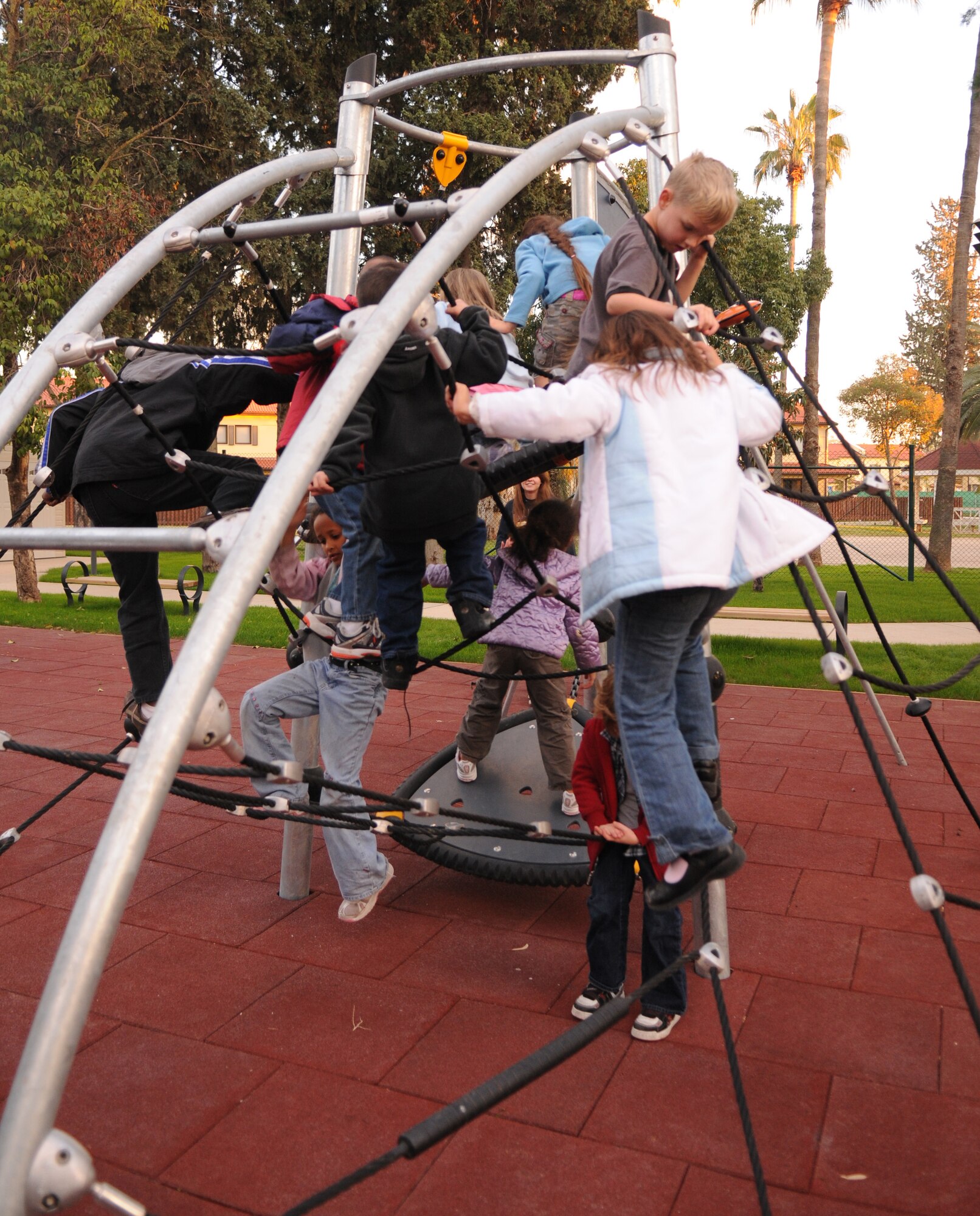 Children from Incirlik Air Base youth center play on the new playground equipment that opened Dec. 12.  (Air Force photo by Airman 1st class Amber Russell)