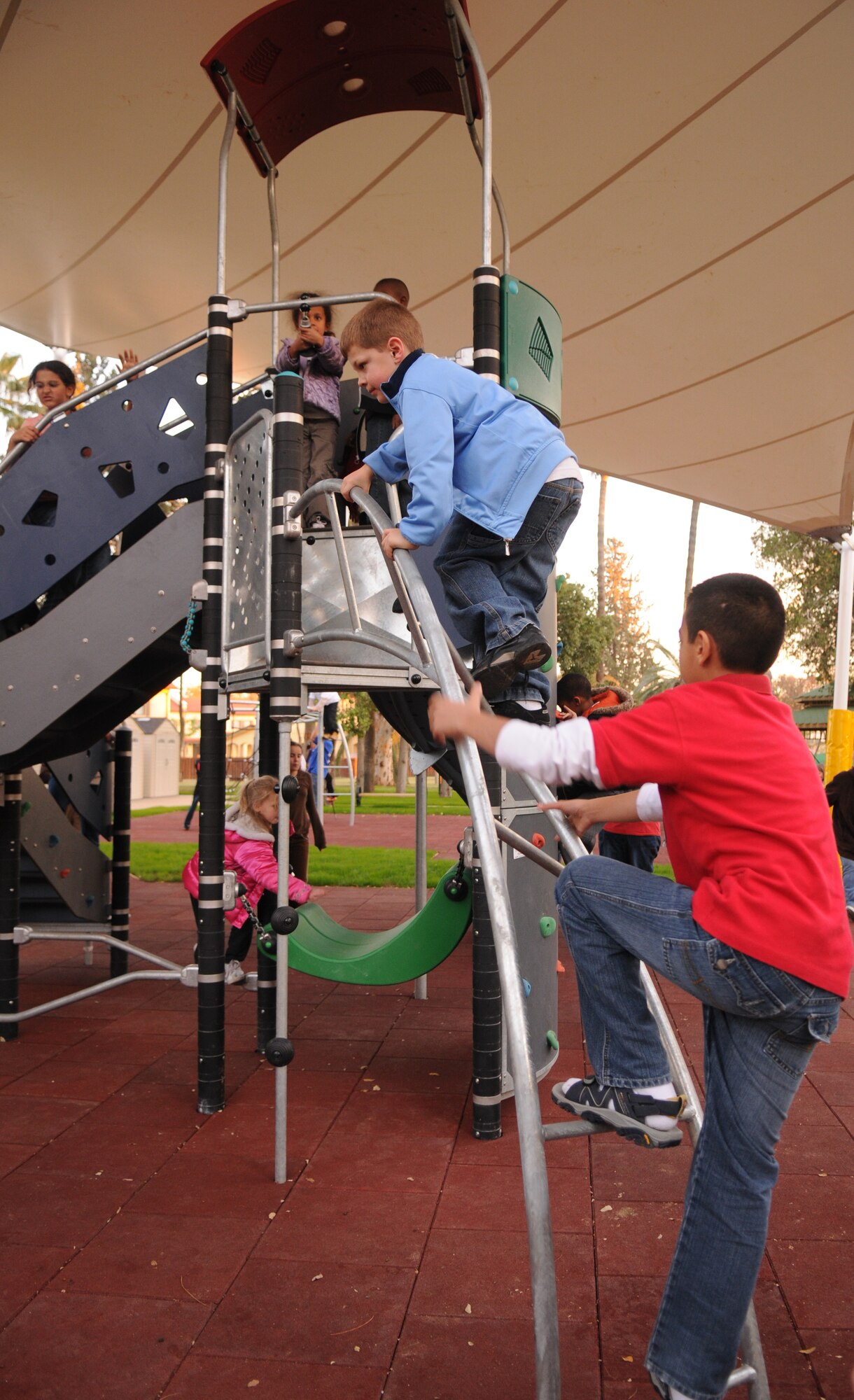 Children from Incirlik Air Base youth center play on the new playground equipment that opened Dec. 12.  (Air Force photo by Airman 1st class Amber Russell)
