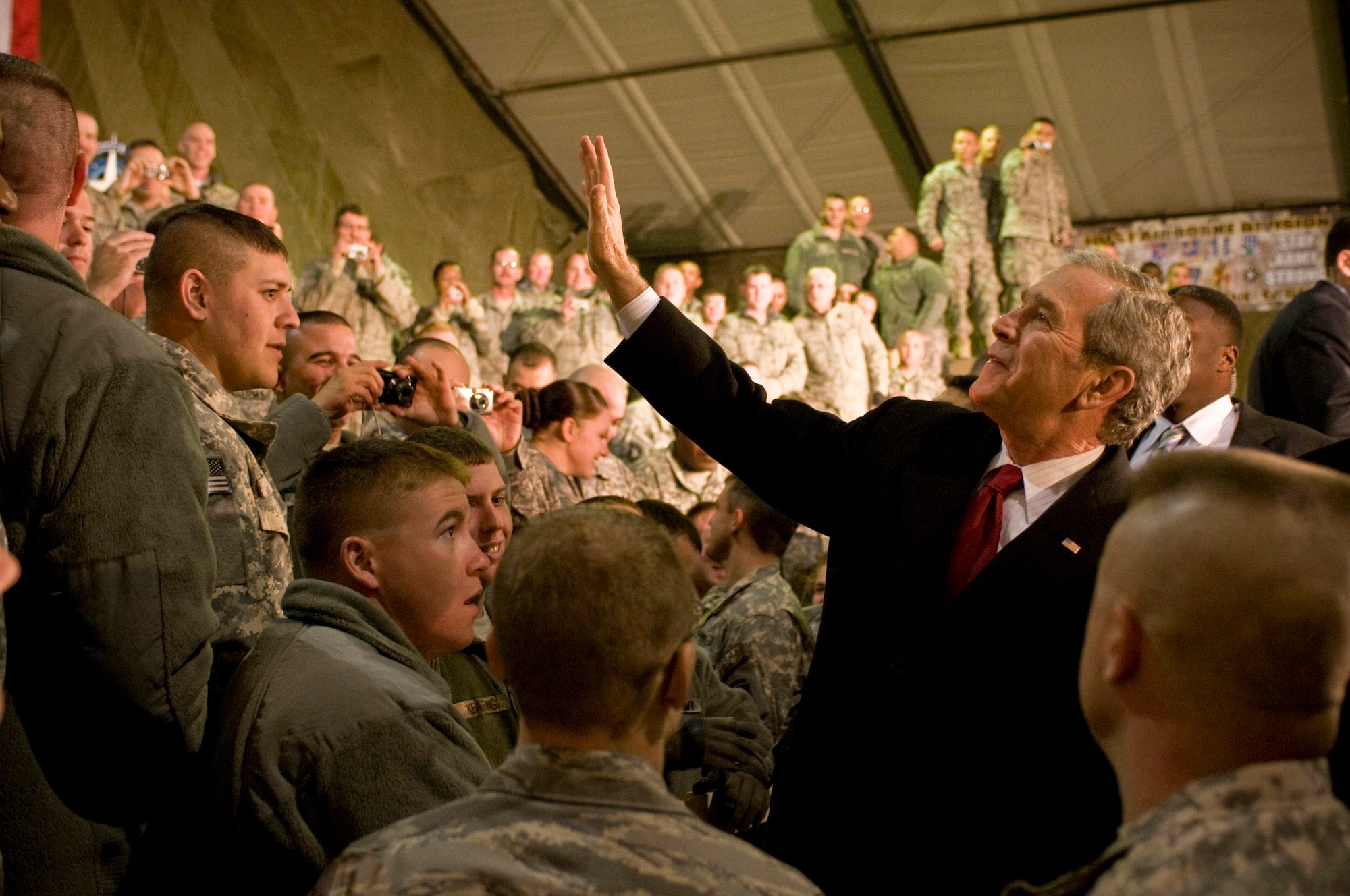 President George W. Bush waves to military members Dec. 15 at Bagram Airfield, Afghanistan. After giving his speech, he took time to shake hands and individually thank troops for their service. (U.S. Air Force photo/Staff Sgt. Samuel Morse)
