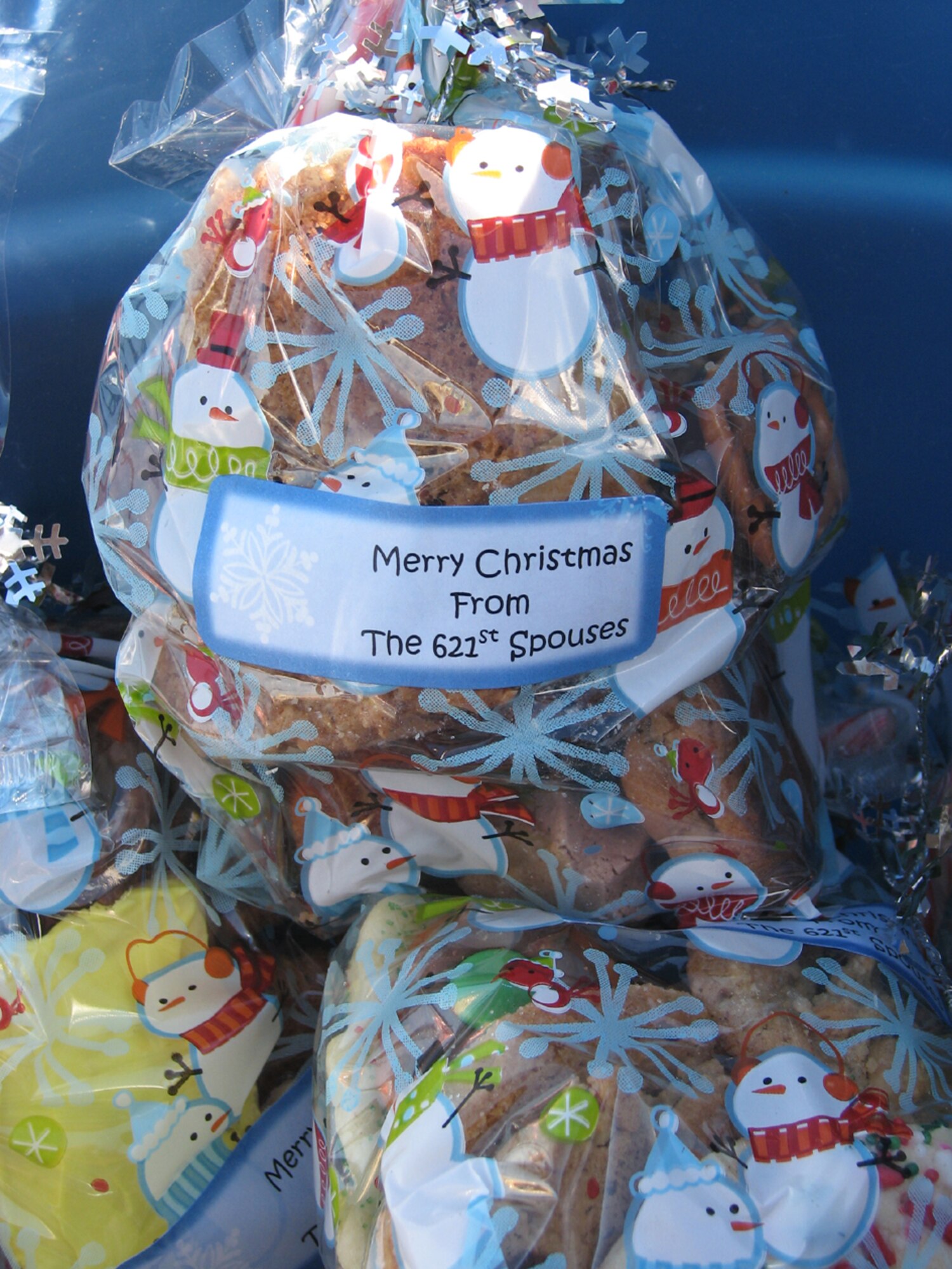 Members of the 621st Contingency Response Wing spouses' club collected, packaged and handed out more than 2,000 home-baked cookies to Airmen here, Dec. 12. An extraordinary task for a simple show of appreciation and holiday cheer, the cookie hand-outs are just one way the Devil Raider spouses help promote Air Mobility Command's mission vision focus area of developing and caring for Airmen and their families. (U.S. Air Force photo/1st Lt Dustin Doyle)