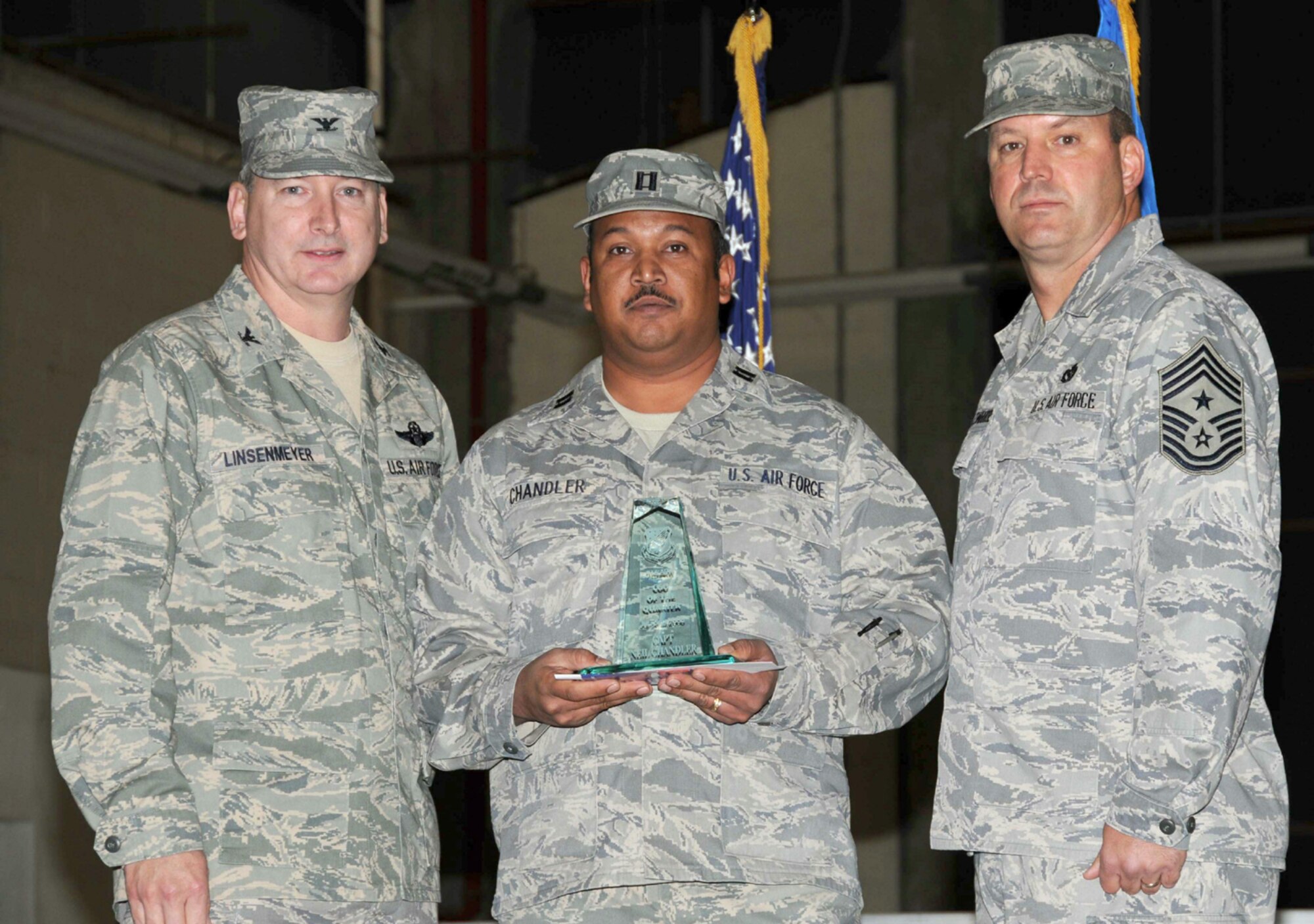 SEYMOUR JOHNSON AIR FORCE BASE, N.C. -- Capt. Neil Chandler (center) receives the Company Grade Officer of the Quarter award for the 916th Air Refueling Wing. Presenting the award is Col. Fritz Linsenmeyer (left), wing commander and Command Chief Master Sgt. Lester Boltinhouse. Capt. Chandler is a Reservist with the 916th Logistics Readiness Squadron.