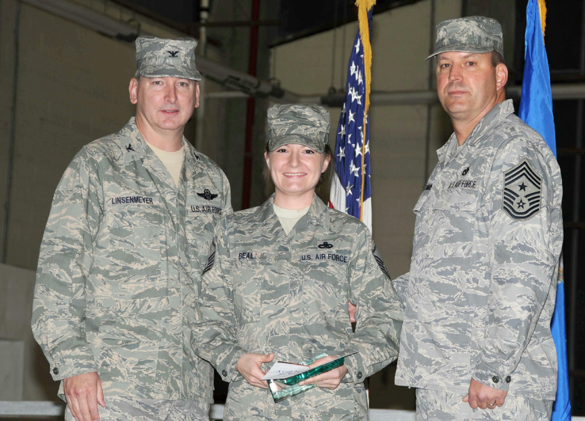 SEYMOUR JOHNSON AIR FORCE BASE, N.C. -- Master Sgt. Rebecca Beal (center) receives the Senior Noncommissioned Officer of the Quarter award for the 916th Air Refueling Wing. Presenting the award is Col. Fritz Linsenmeyer (left), wing commander and Command Chief Master Sgt. Lester Boltinhouse. Sgt. Beal works with the 911th Air Refueling Squadron.
