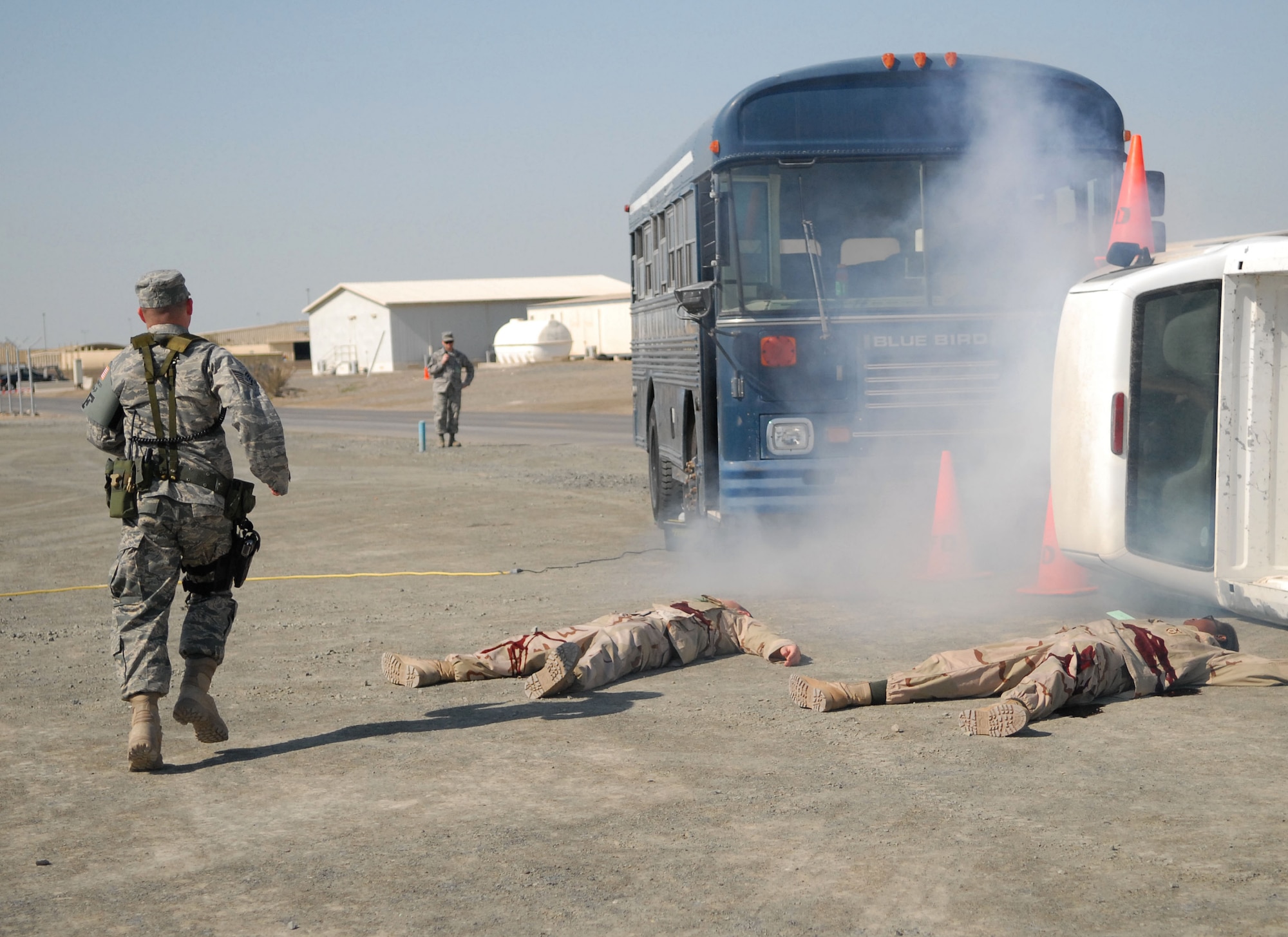 SOUTHWEST ASIA -- A member of the 380th Expeditionary Security Forces Squadron is the first to respond to simulated victims at the scene of a simulated terrorist attack here Dec. 12. Make up is applied to the simulated, or moulage, victims to lend an air of reality to the situation. The deployed Airmen are all part of an exercise which tests and evaluates the 380th Air Expeditionary Wing's response to real-world scenarios. (US Air Force photo by Tech. Sgt. Denise Johnson) (released)
