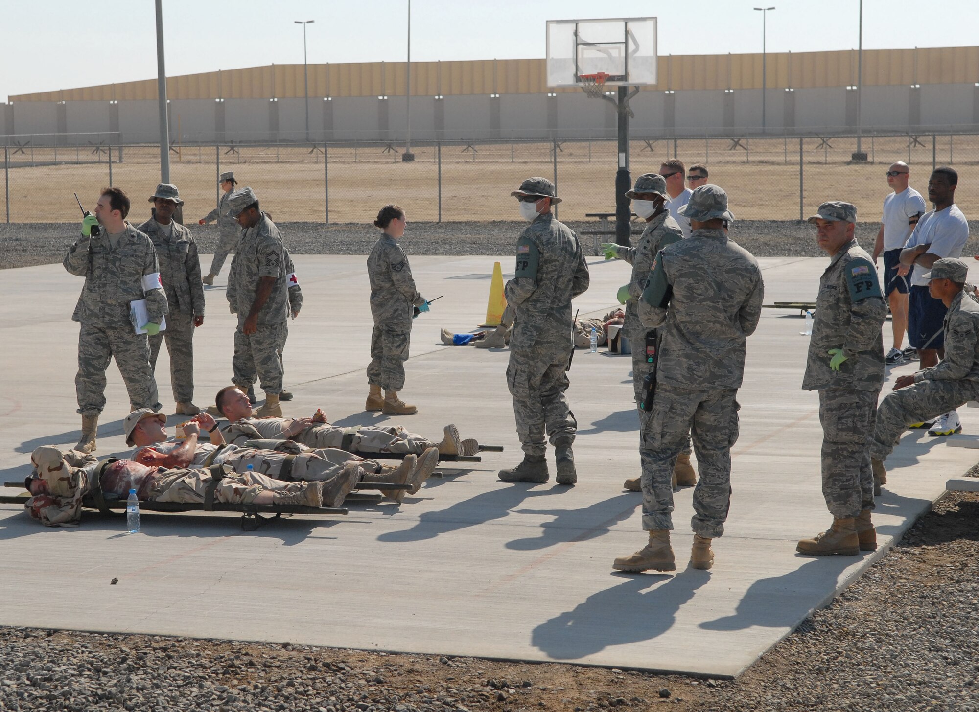 SOUTHWEST ASIA -- Members of the 380th Expeditionary Medical Group see to simulated victims at the Casualty Collection Point after a simulated terrorist attack here Dec. 12. The deployed Airmen are all part of an exercise which tests and evaluates the 380th Air Expeditionary Wing's response to real-world scenarios. (US Air Force photo by Tech. Sgt. Denise Johnson) (released)