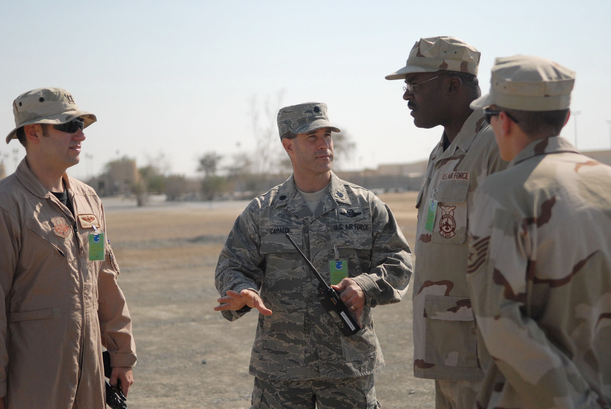 SOUTHWEST ASIA -- Left to right: Capt. Chris Batterton, 380th Air Expeditionary Wing Safety; Lt. Col. Shane Capaldi, 380th Air Expeditionary Wing Plans and Programs; Tech. Sgts. Brian Miller and Jack Hartman, both of the 380th Expeditionary Civil Engineer Fire and Emergency Services Flight, all gather at the scene of a simulated terrorist attack here Dec. 12. The Airmen are all part of the Exercise Evaluation Team who plan and implement exercises to test and evaluate the 380th Air Expeditionary Wing's response to real-world scenarios. (US Air Force photo by Tech. Sgt. Denise Johnson) (released)