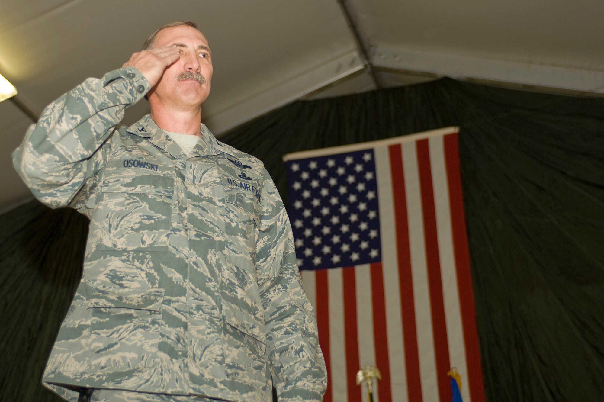 Col. Theodore Osowski returns his first salute as commander of the 451st Air Expeditionary Group during a change of command ceremony Dec. 13 at a base in Southern Afghanistan. The 451st AEG mission includes launching and recovering unmanned aerial systems, and providing medical evacuations with the HH-60 Pave Hawk. (U.S. Air Force photo by Staff Sgt. Rachel Martinez) (Released)