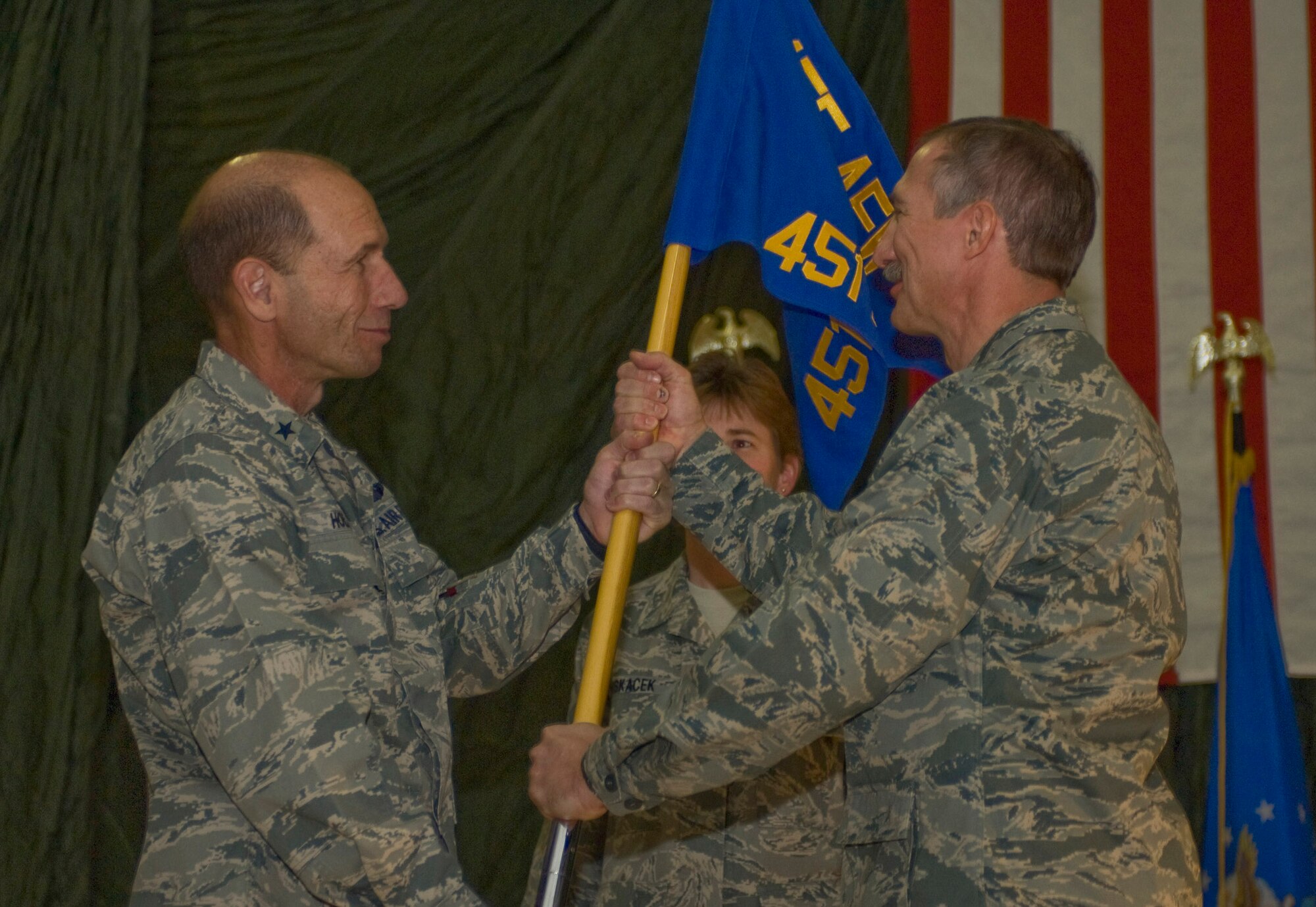 Col. Theodore Osowski accepts the 451st Air Expeditionary Group guidon from Brig. Gen. Mike Holmes, 455th Air Expeditionary Wing commander, during a change of command ceremony Dec. 13 at a base in Southern Afghanistan. Colonel Osowksi assumed command of the 451st AEG from Col. Luther Turner.  (U.S. Air Force photo by Staff Sgt. Rachel Martinez) (Released)