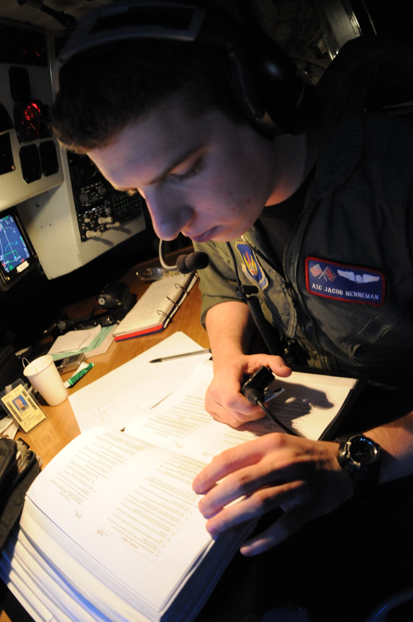 Airman 1st Class Jacob Nenneman, a boom operator with the 351st Air Refueling Squadron, reviews air refueling procedures with the aircraft commander, Capt. Chris Saettel prior to refueling a MC-130 Hercules cargo plane from the 352nd Special Operations Group, both from RAF Mildenhall. The aircraft were traveling to a rescue mission involving a critically injured crewman on a cargo vessel off the coast of Ireland. Refueling procedures vary based on the aircraft being refueled. The KC-135 provided 42 thousand pounds of fuel for the mission. (U.S. Air Force Photo by Master Sgt. Charles Tubbs)