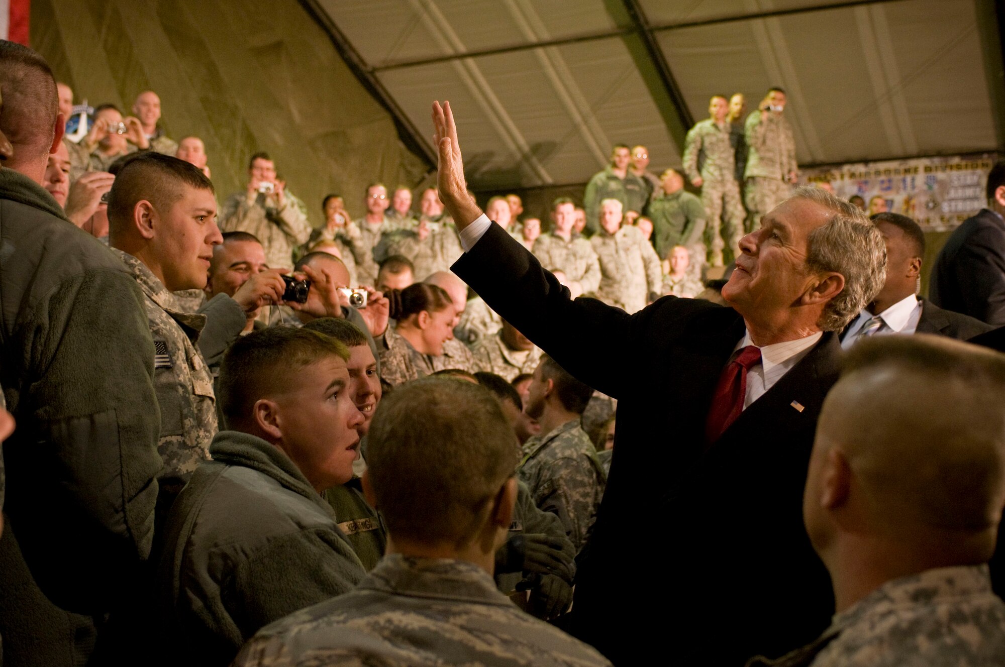 President George W. Bush waves to military members at Bagram Air Field, Afghanistan, Dec. 15. After giving his speech, he took time to shake hands and individually thank troops for their service. (U.S. Air Force photo by Staff Sgt. Samuel Morse)(Released)