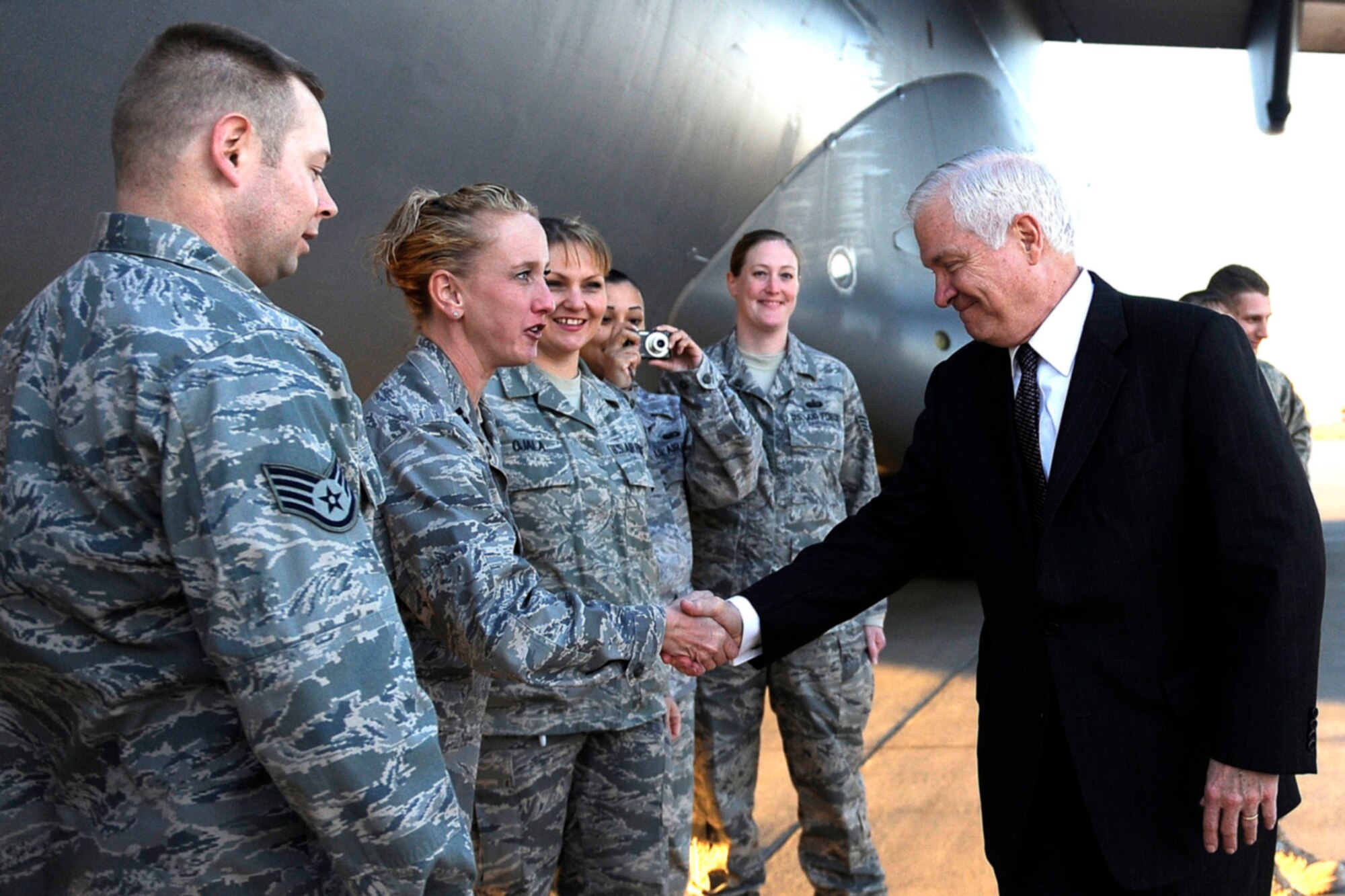 Secretary of Defense Robert Gates talks with Airmen assigned to the 332nd Air Expeditionary Wing Protocol Office prior to departing Joint Base Balad, Iraq, Dec. 13. Gates was in Iraq wrapping up a four-day tour of the Middle East to meet with regional commanders and troops.  (U.S. Air Force photo/Tech Sgt Jerry Morrison)