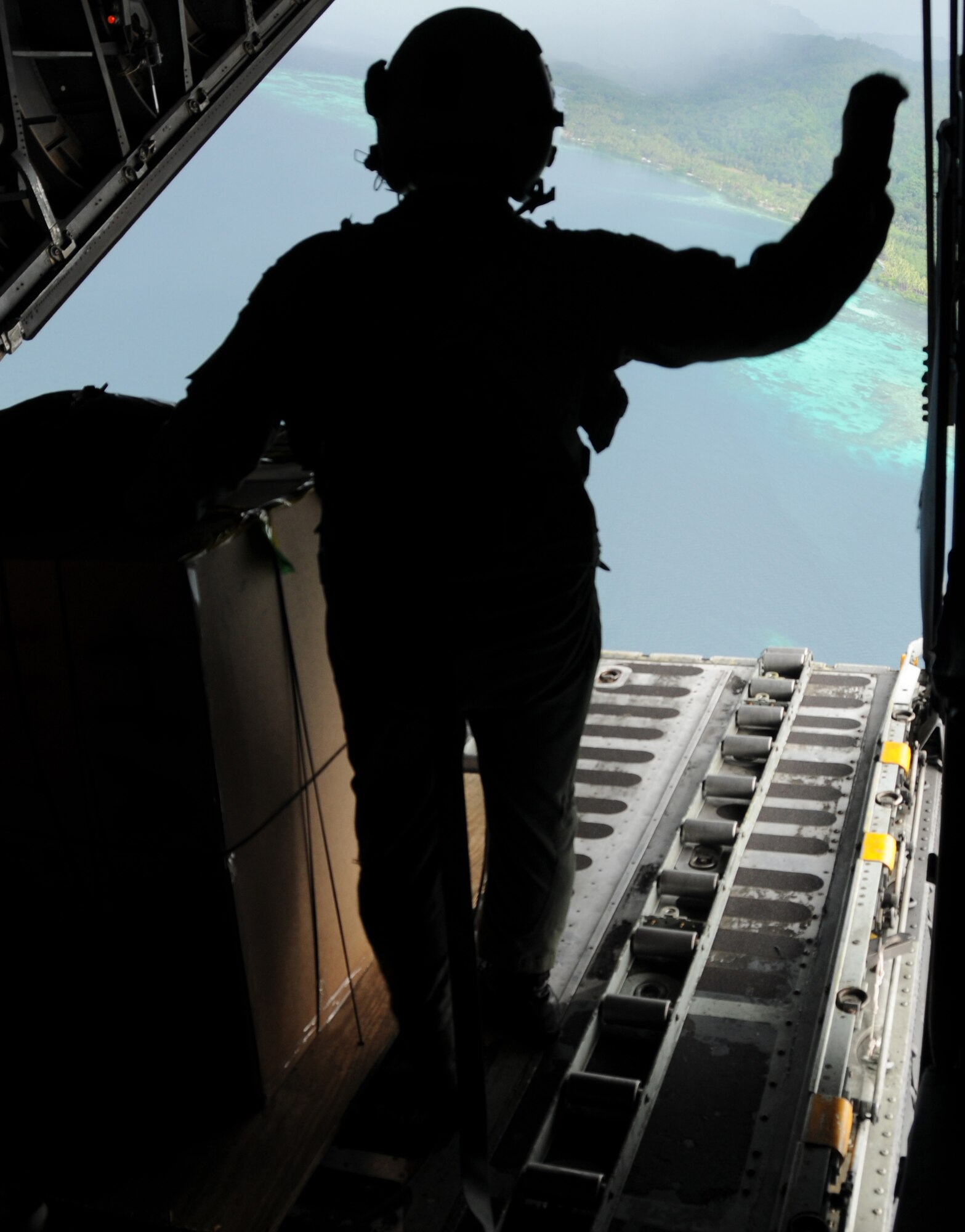 ANDERSEN AIR FORCE BASE, Guam - Staff Sgt. Ian Hunt, 36th Airlift Squadron loadmaster, waits for the right moment Dec. 14 to push the first of more than 180 packages to be dropped during the 2008 Operation Christmas Drop. Operation Christmas Drop is the Air Force’s longest-running humanitarian which began in 1952. Airmen today continue the tradition delivering supplies to remote islands of the Commonwealth of the Northern Marianas Islands, Yap, Palau, Chuuk and Pohnpei. (U.S. Air Force photo by Staff Sgt Jamie Lessard)