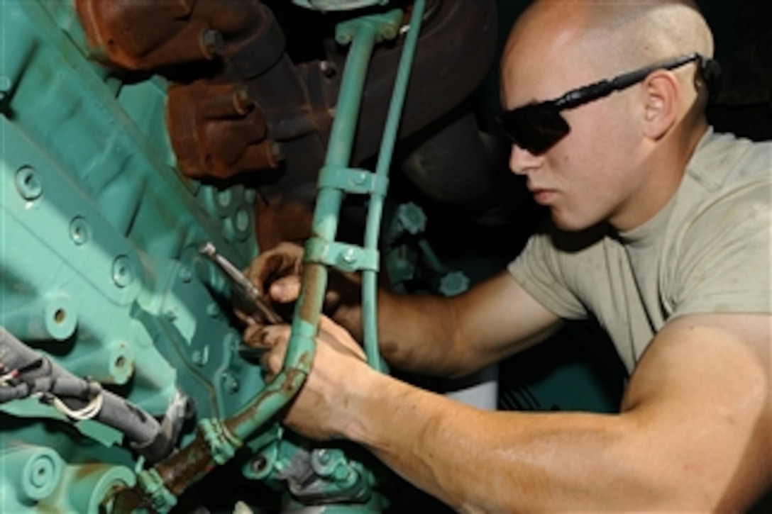 U.S. Air Force Senior Airman Andrew Zeigler replaces an oil cooler gasket on a power generator at Joint Base Balad, Iraq, on Dec. 8, 2008.  Zeigler is an electrical power production journeyman with the 332nd Expeditionary Civil Engineer Squadron.  
