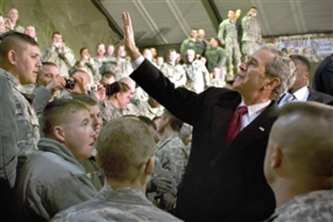 President George W. Bush waves to military members on Bagram Air Field, Afghanistan, Dec. 15, 2008. After giving a speech, he shook hands and individually thanked troops for their service.