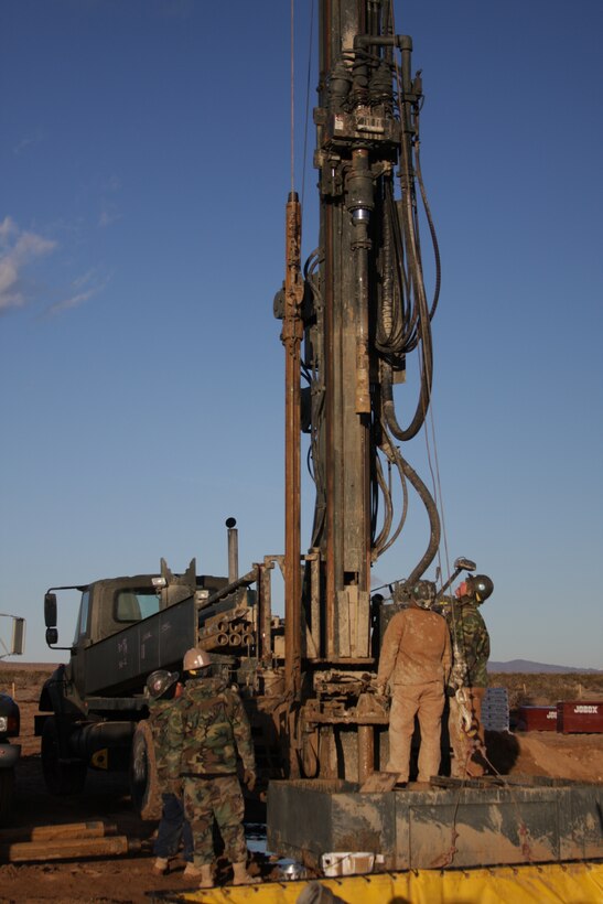 Seabees with the Naval Mobile Construction Battalion 40 drilling team from Naval Base Ventura County, Port Hueneme, Calif., erect a drill tower for work at the Combat Center’s West training area Tuesday, Dec. 16, 2008. The Seabees are helping the Public Works Division find hot spots for geothermal energy in the West training area, which can be used to support the base and cut down energy usage.
