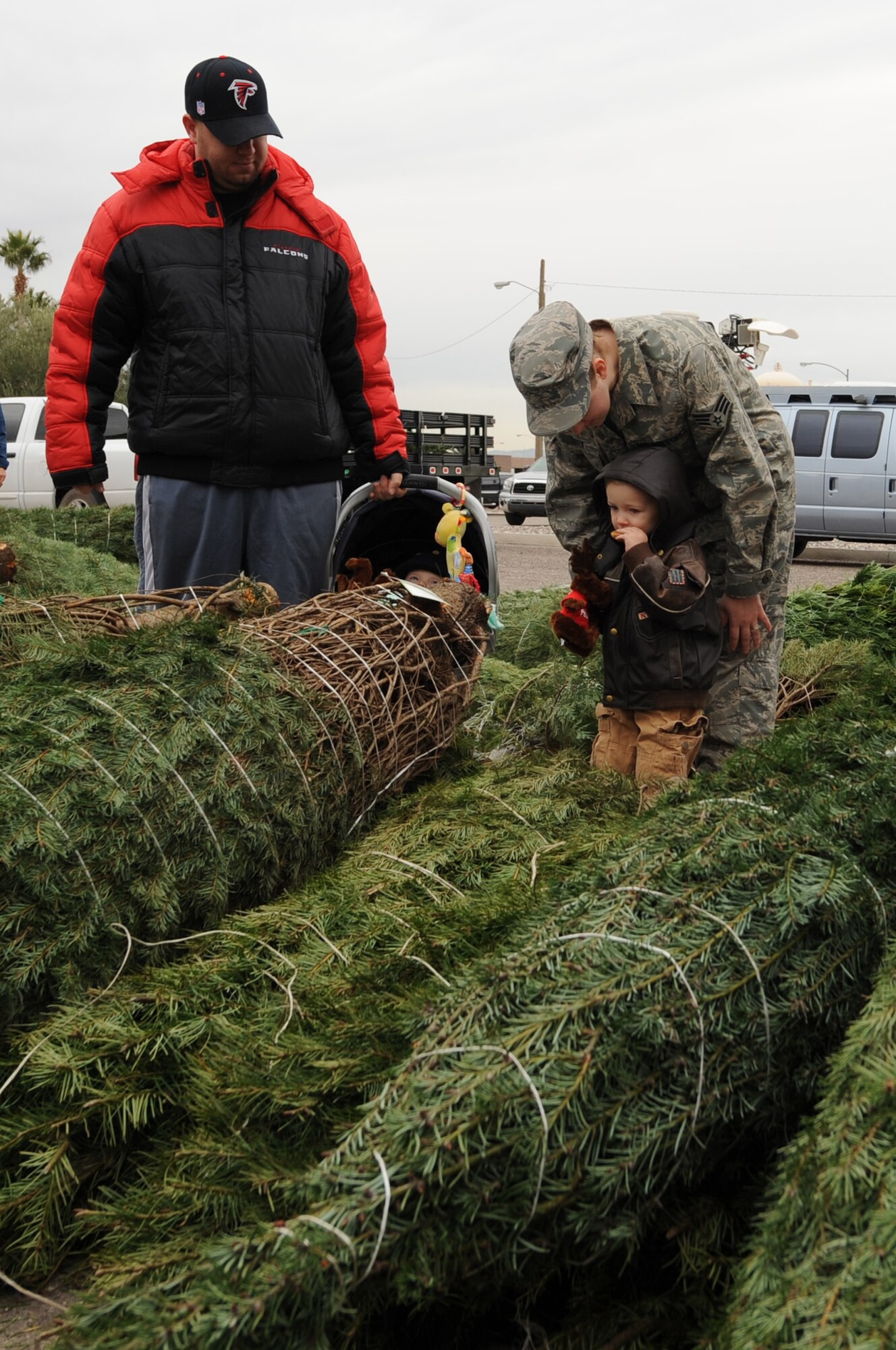 Senior Airman Roger Ramey Jr., 57th Aircraft Maintenance Squadron F-15 crew chief, and Senior Airman Amber Ramey, 99th Medical Equipment Repair, pick out a Christmas tree with their two sons, 5-month-old Derek and 2-year-old Jacob, on Nellis Air Force Base, Nev., Dec. 12, 2008. Trees for Troops, a charity program sponsored by the Christmas SPIRIT Foundation and FedEx, donated approximately 750 Christmas trees to Nellis and Creech Airmen and their families. (U.S. Air Force Photo / Airman 1st Class Stephanie Rubi)