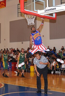 ANDERSEN AIR FORCE BASE, Guam - Jermaine "Hi Rise" Brown leap frogs over the referee to slam dunk the ball here Dec. 15.  The Harlem Globetrotters entertained Andersen's Airmen and their families on Monday night during a game played against the Washington Generals.   (U.S. Air Force photo by Staff Sgt. Jamie Lessard)