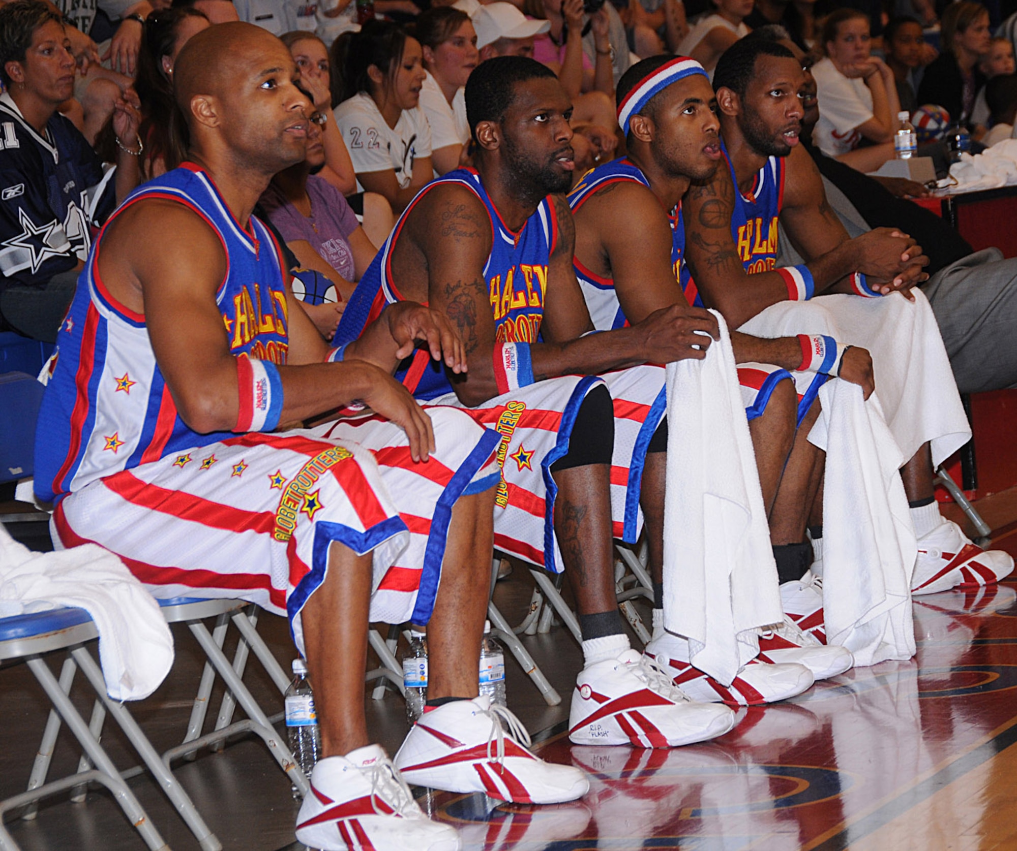 ANDERSEN AIR FORCE BASE, Guam - Harlem Globetrotters look on as their teammates battle the Washington Generals here Dec. 15.  The world famous Globetrotters have been undefeated for 83 years.   (U.S. Air Force photo by Staff Sgt. Jamie Lessard)