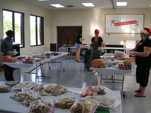 ANDERSEN AIR FORCE BASE, Guam -- Volunteers at this year's Cookie Caper event, held at the Chapel 2 Annex Dec. 15, worked at different stations to ensure efficiency throughout the event. Volunteers decorated bags, cut ribbon, made cards and posters, assembled cookie bags and delivered cookie trays across the base. (Courtesy photo)