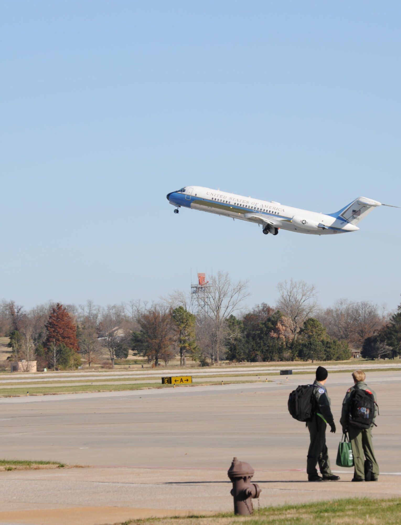 Fly baby, fly!  932nd Airlift Wing Air Force Reservists watch in awe as a C-9C lifts off from Scott Air Force Base during a recent Unit Training Assembly weekend.  The wing continues to hire flight attendants to travel on the C-9C and C-40C.  (U.S. Air Force photo/Maj. Stan Paregien)