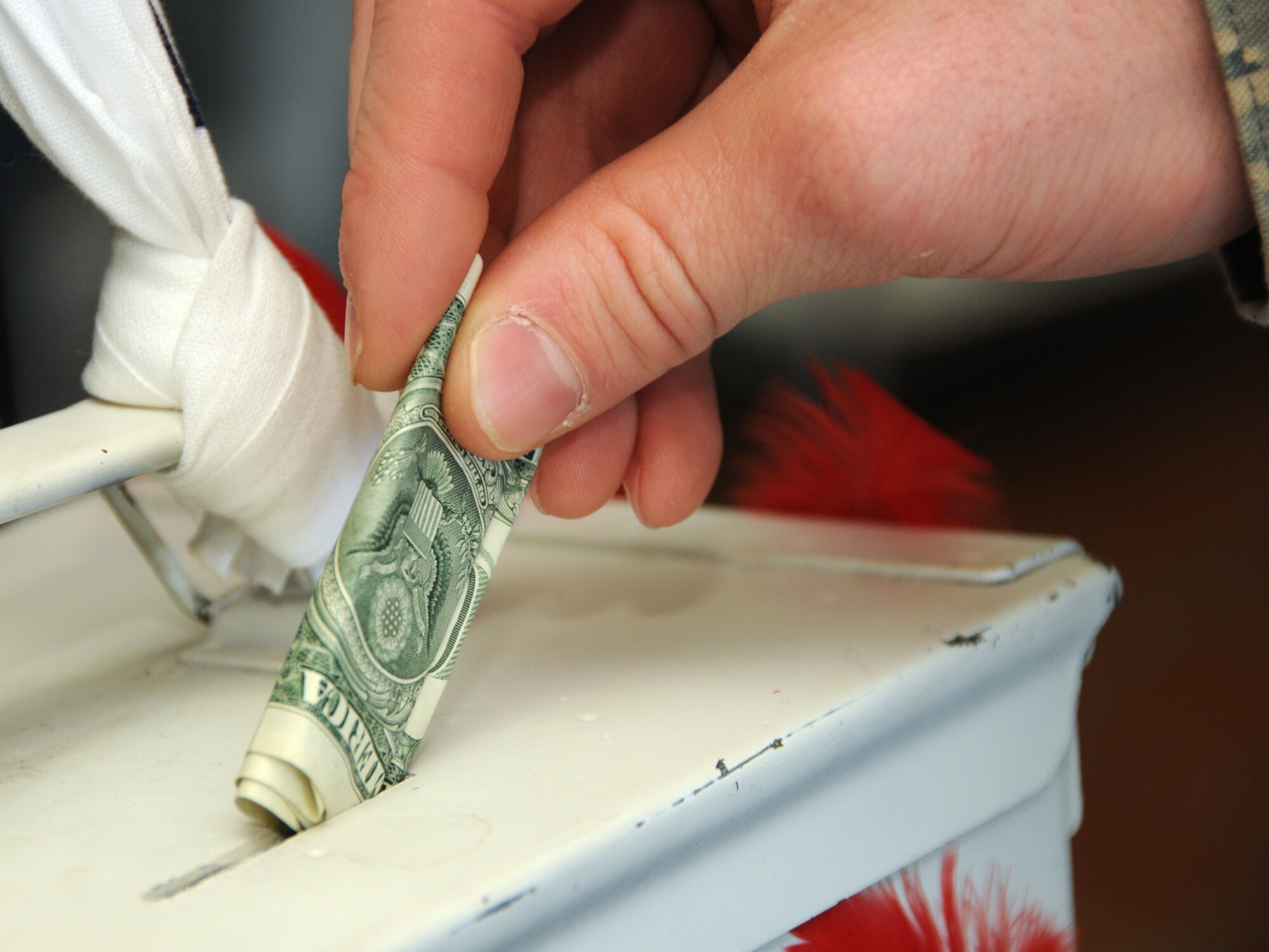 MISAWA AIR BASE, Japan -- Senior Airman Lee Hammes, 35th Maintenance Squadron, makes a donation to the Red Feather Community Chest Campaign Dec. 16, 2008. The campaign runs from Dec. 16 to Dec. 30, and contributions will be used to support various welfare organizations within the Misawa City chapter. (U.S. Air Force photo by Senior Airman Jamal D. Sutter)