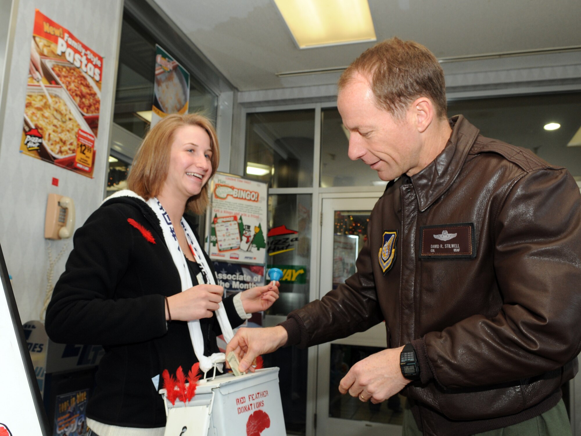 MISAWA AIR BASE, Japan -- Col. David Stilwell, 35th Fighter Wing commander, contributes one of the first donations to this year's Red Feather Community Chest Campaign Dec. 16, 2008. Running from Dec. 16 to Dec. 30, campaign stations can be found throughout various places on base to include the Base Exchange, commissary and shoppette. (U.S. Air Force photo by Senior Airman Jamal D. Sutter)
