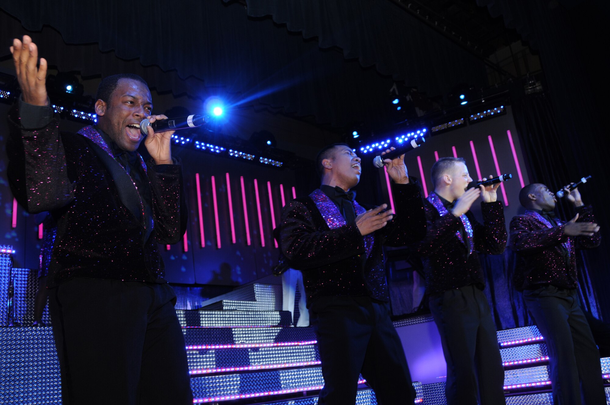 Senior Airman Tommie Crutcher and Tops in Blue performers sing and dance during their annual world tour "Deja Blue" celebrating 55 years of entertainment Dec. 10, 2008, Eielson Air Force Base, Alaska.  Airman Crutcher is a Tops in Blue vocalist.  Tops in Blue showcases music, dance and comedy -- all performed by active-duty Airmen who perform two hours of non-stop live entertainment.   (U.S Air Force photo/Staff Sgt. Tia Schroeder)                                                                                                                                                                                                                                                                                                                           