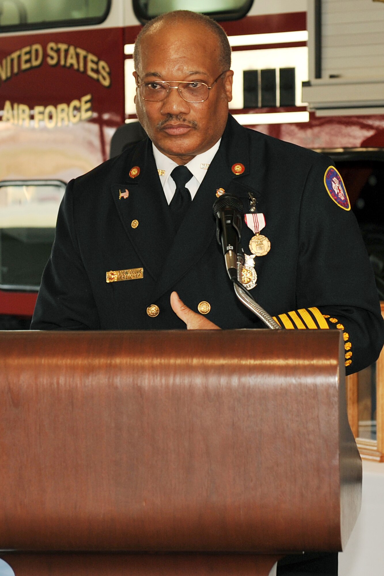 OFFUTT AIR FORCE BASE, Neb. - U. S. Air Force retired Fire Chief Robin Gullie, 55th Civil Engineer Squadron, gives his final speech celebrating his 38 years of service to the Air Force during his retirement ceremony Dec. 12 at the Fire Station. (Photo By: Charles Haymond). 