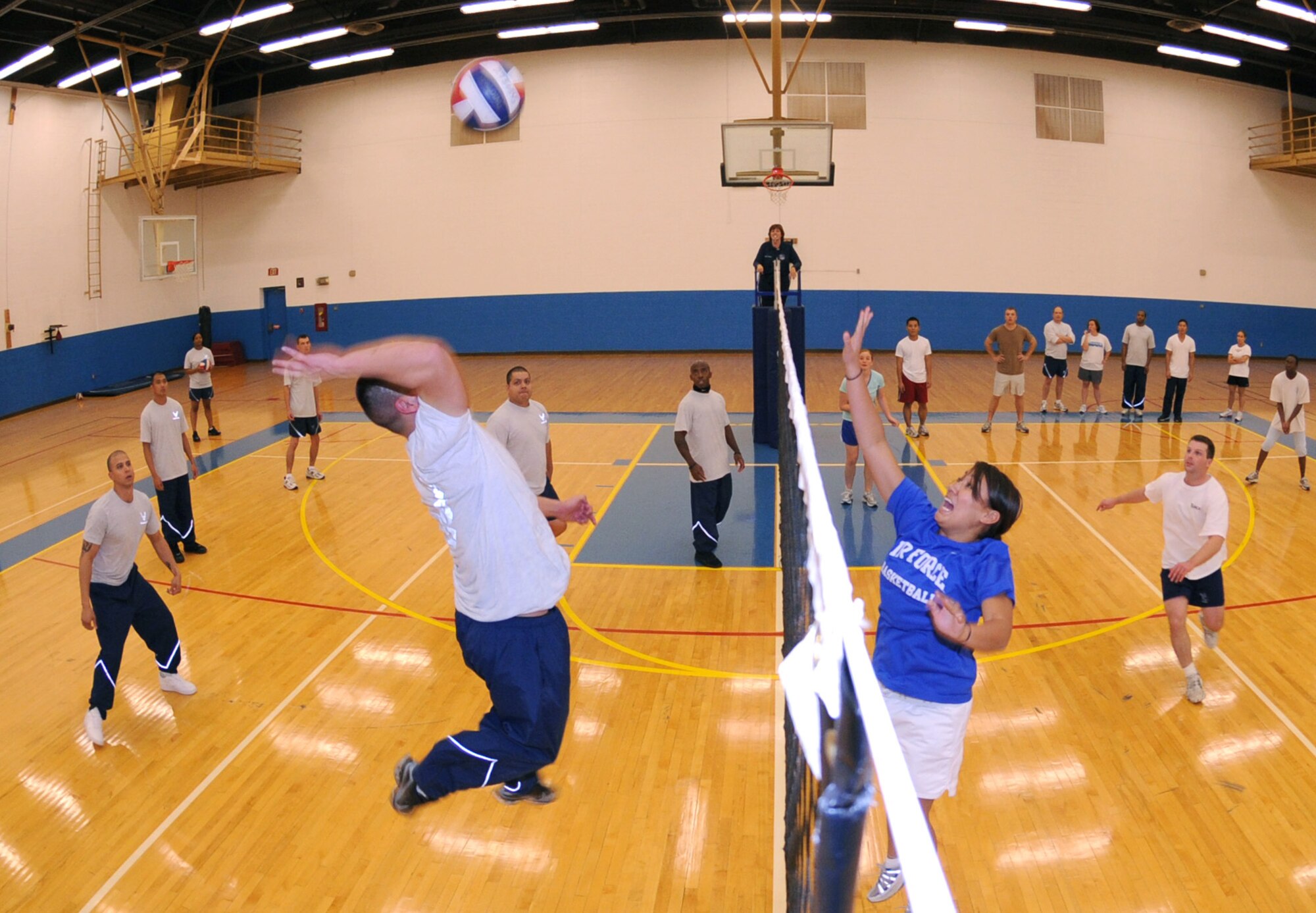 CANNON AIR FORCE BASE, N.M. -- Senior Airman Christopher Ruiz, 27th Special Operations Civil Engineer Squadron, gets ready to drive the volleyball over the net while 2nd Lt. Amanda Altman, 27th Special Operations Communications Squadron prepares her defense. The Airman Leadership School Predator team and the Company Grade Officers compete against each other regularly in a variety of sports. The CGOs won two of the three volleyball games gainst the ALS team. (Airman 1st Class Maynelinne De La Cruz)  