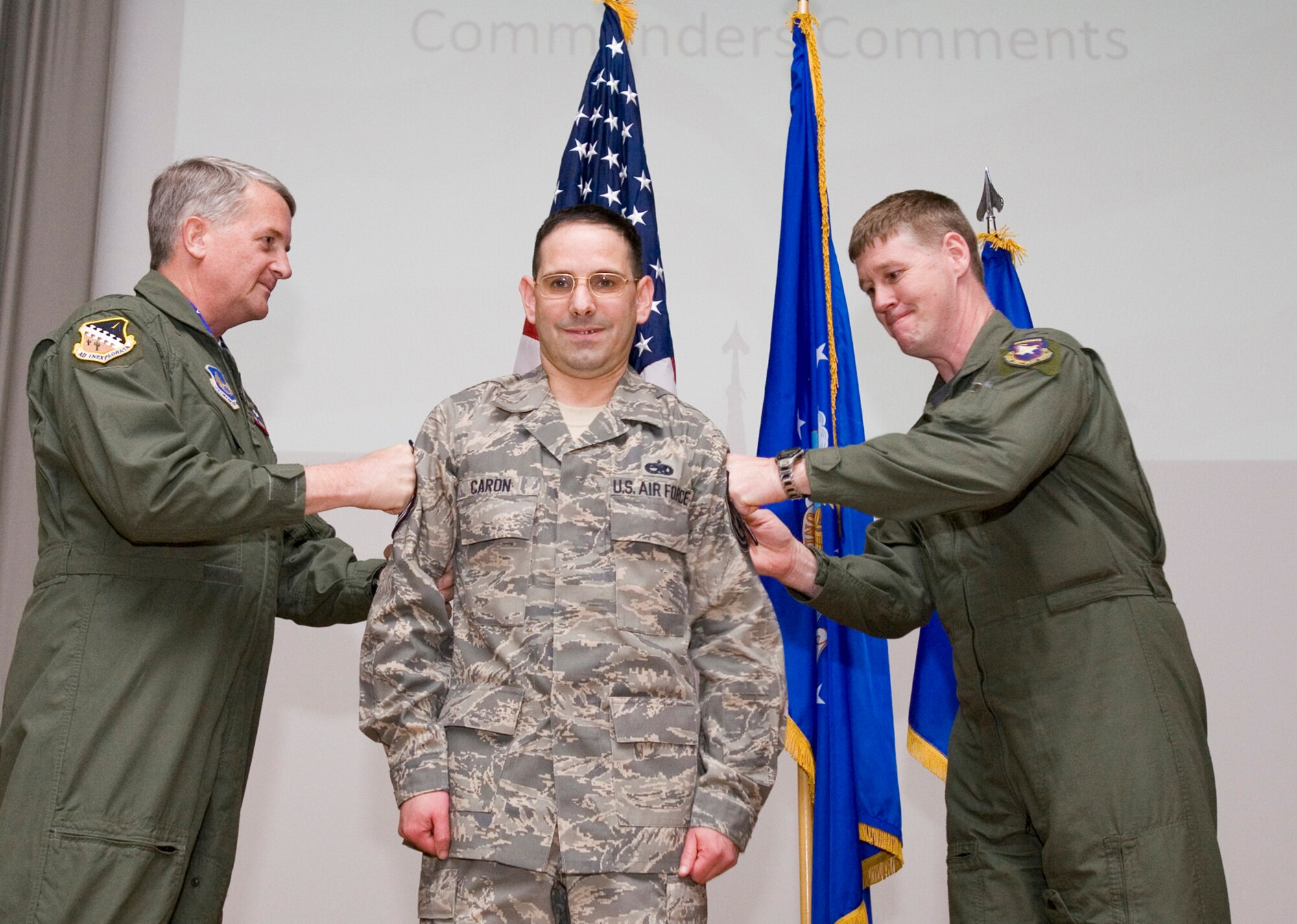 Maj. Gen. David Eichhorn (left), Air Force Flight Test Center commander, and Col. William Thornton, 412th Test Wing commander, tack on a new stripe for Master Sgt. Steven Caron, 412th Maintenance Squadron section supervisor, during an award ceremony at the base theater Dec. 12. Sergeant Caron was promoted to the rank of master sergeant through the Stripes to Exceptional Performers program, or STEP. (Air Force photo by Jet Fabara)
