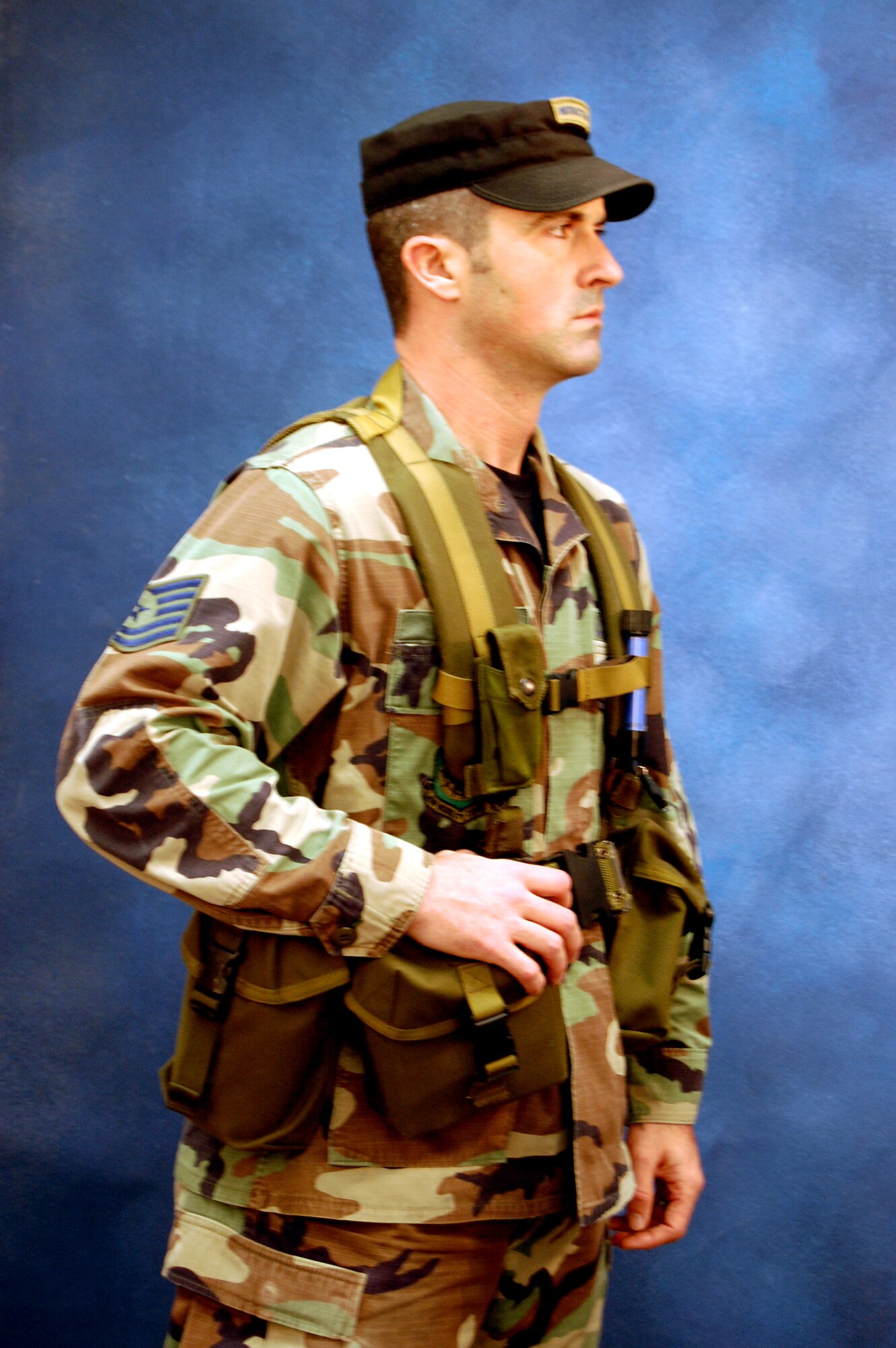 Tech. Sgt. Sean Graves, contingency skills instructor with the U.S. Air Force Expeditionary Center's 421st Combat Training Squadron, models for a photo Dec. 11, 2008, in the Expeditionary Center studio on Fort Dix, N.J.  The effort was part of preparatory work by an artist from the Air Force Art Program to complete a painting highlighting Expeditionary Center Airmen. (U.S. Air Force Photo/Tech. Sgt. Scott T. Sturkol)