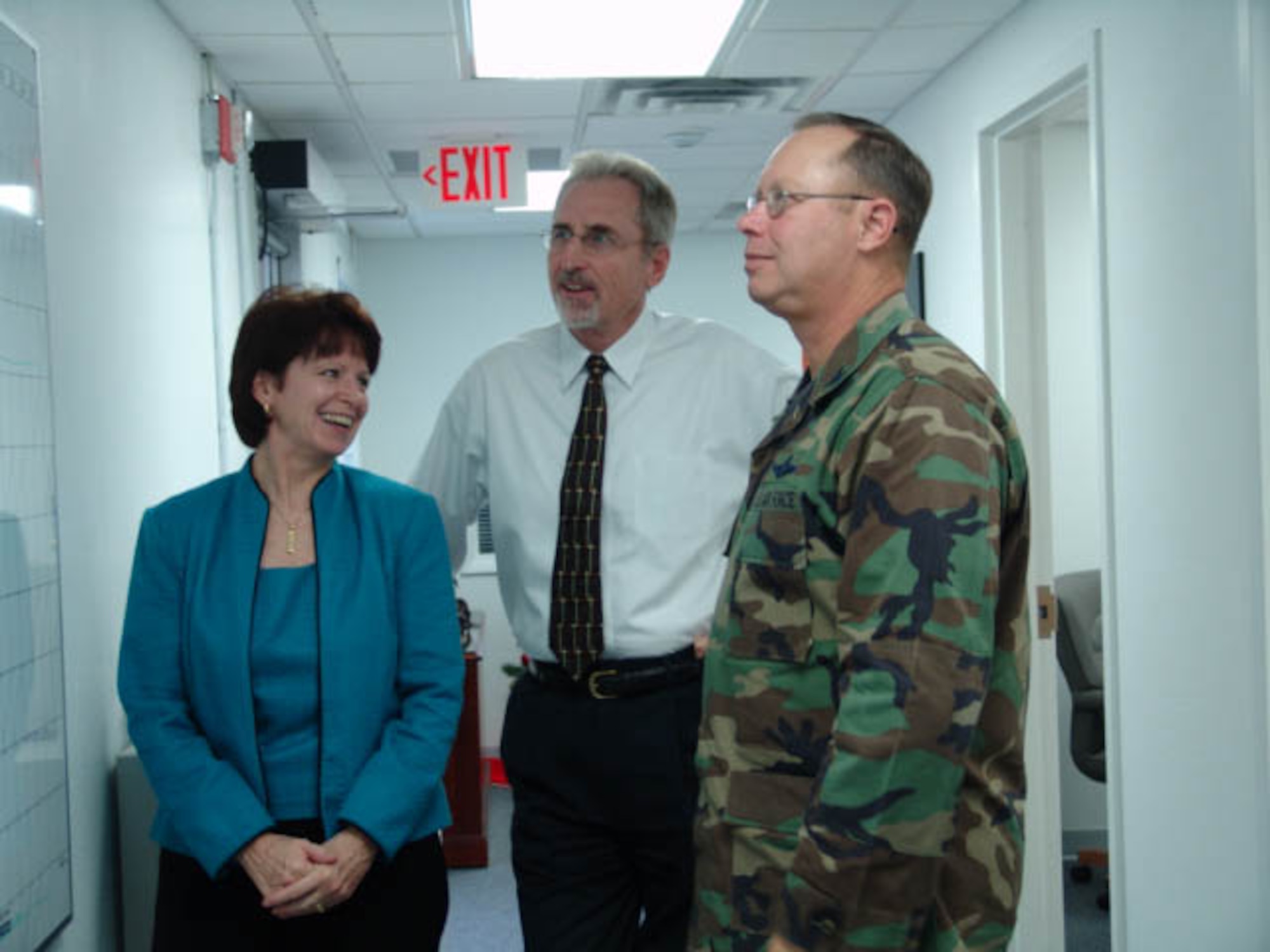 The Inspector General team, Christine Andrews, Bob Buckland and Col. Bradley Denison, check their schedule.  The IG is available to provide a credible system for processing complaints. (USAF photo/Lois Walsh)