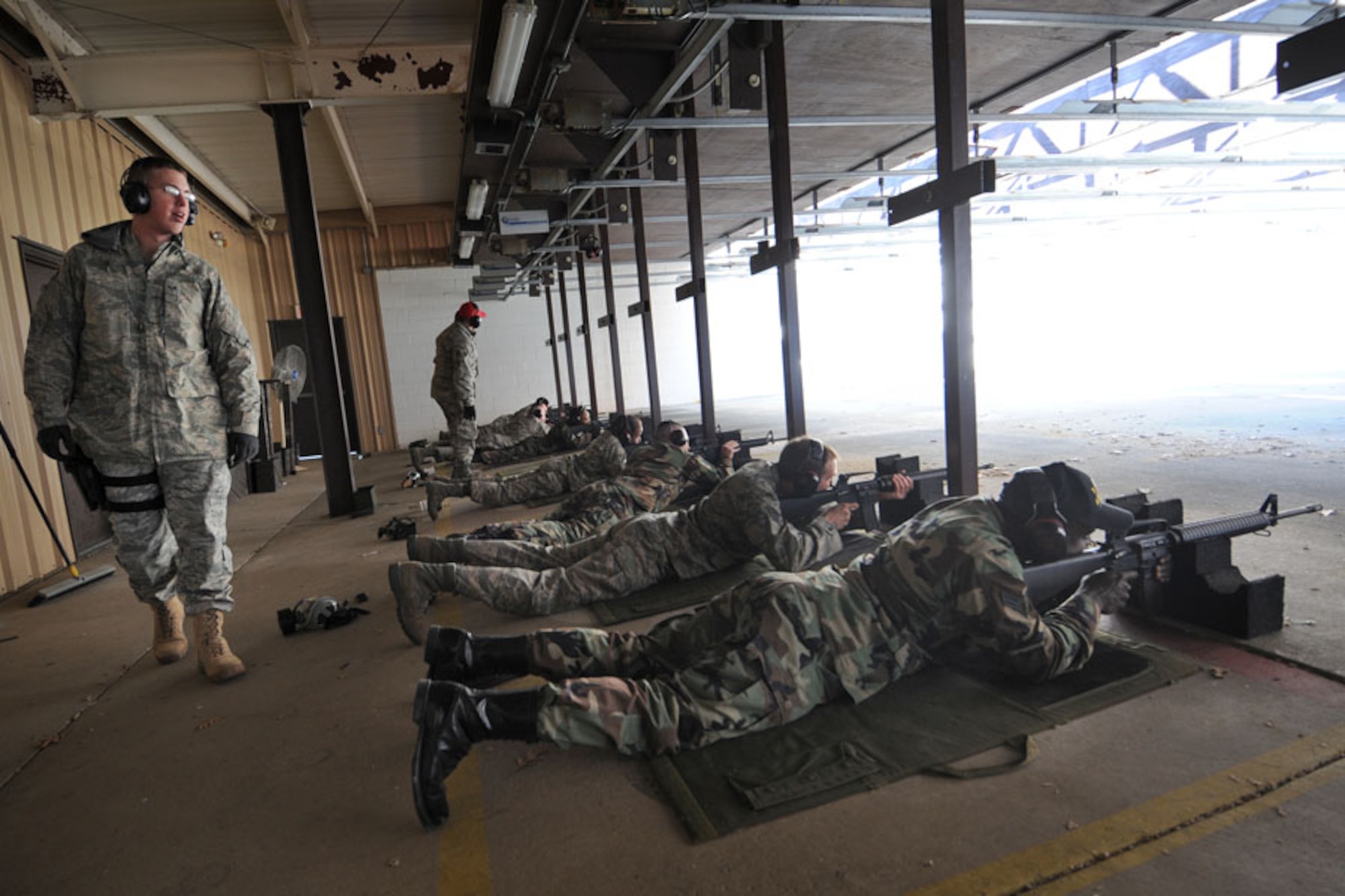 SCOTT AIR FORCE BASE, Ill. -- Senior Airman Ryan Poteet, 375th Security Forces Squadron Combat Arms instructor, looks as trainees fire their M-16s downrange during their qualification class. Trainers watch over the students to ensure proper firing techniques are being utilized and no unsafe actions are being performed.

(U.S. Air Force photo/Senior Airman Jonathan Lovelady)