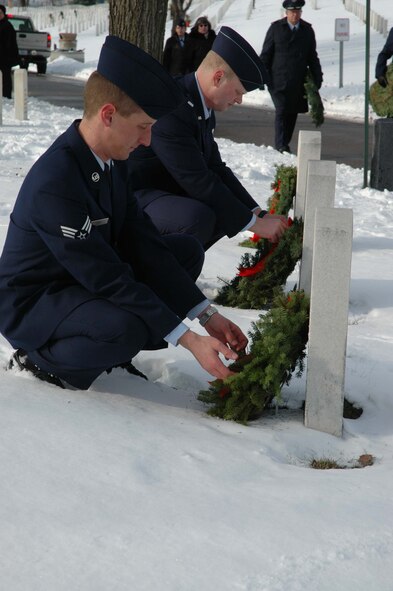 Senior Airman Justin Gort (left) and 1st Lt. Brandon Schrader, 96th Airlift Squadron, lay wreaths at Fort Snelling. (Air Force Photo/Capt. S.J. Brown)