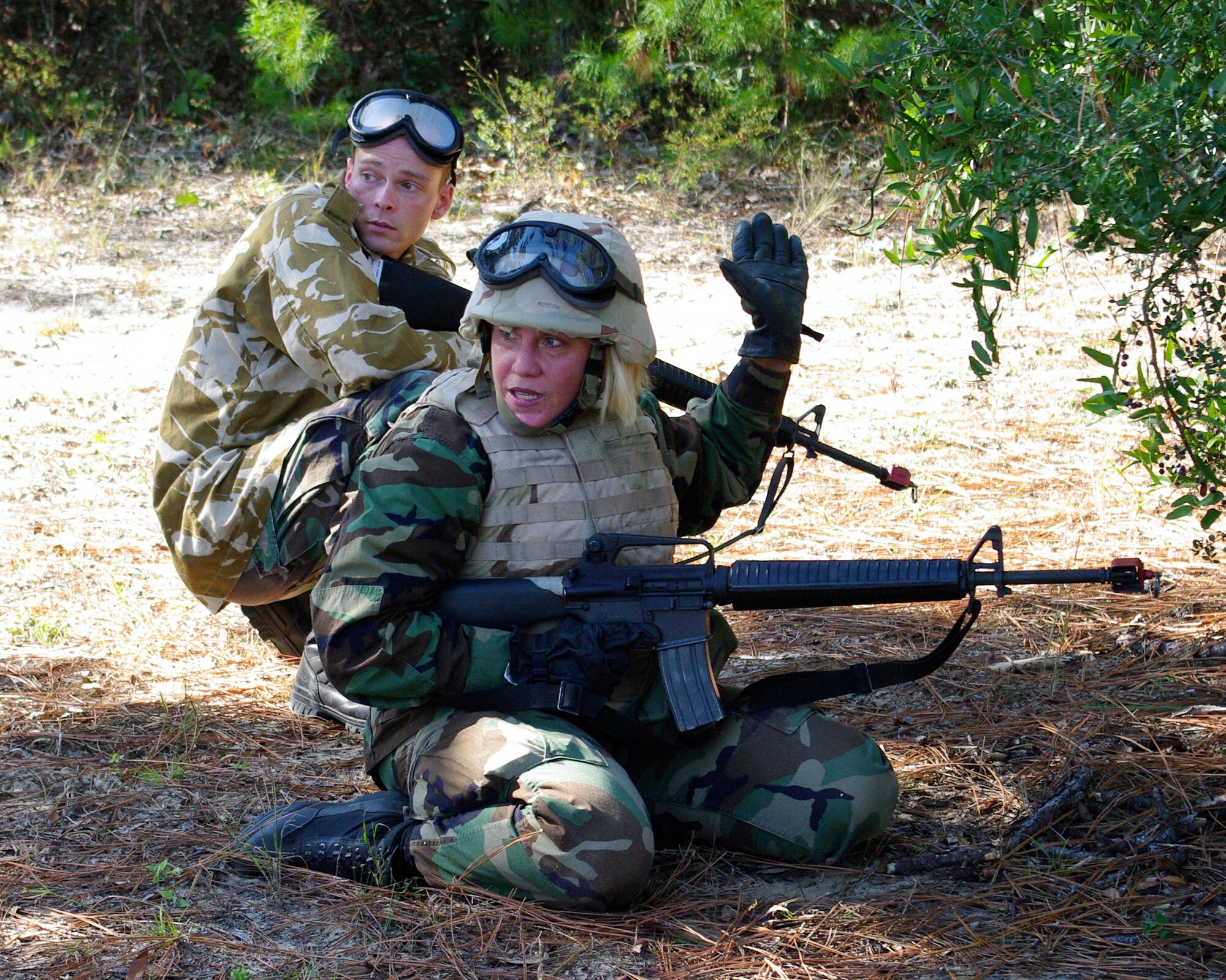 Capt. Marilyn Worgull, 96th Surgical Operations Squadron perioperative clinical nurse, works with an Airman role playing a coalition forces member from Great Britain to evade the "enemy" during Combat Skills Training Oct. 22. Airmen have to go through this course before attending advanced pre-deployment training. (U.S. Air Force Photo/Capt. Robert Sugg)