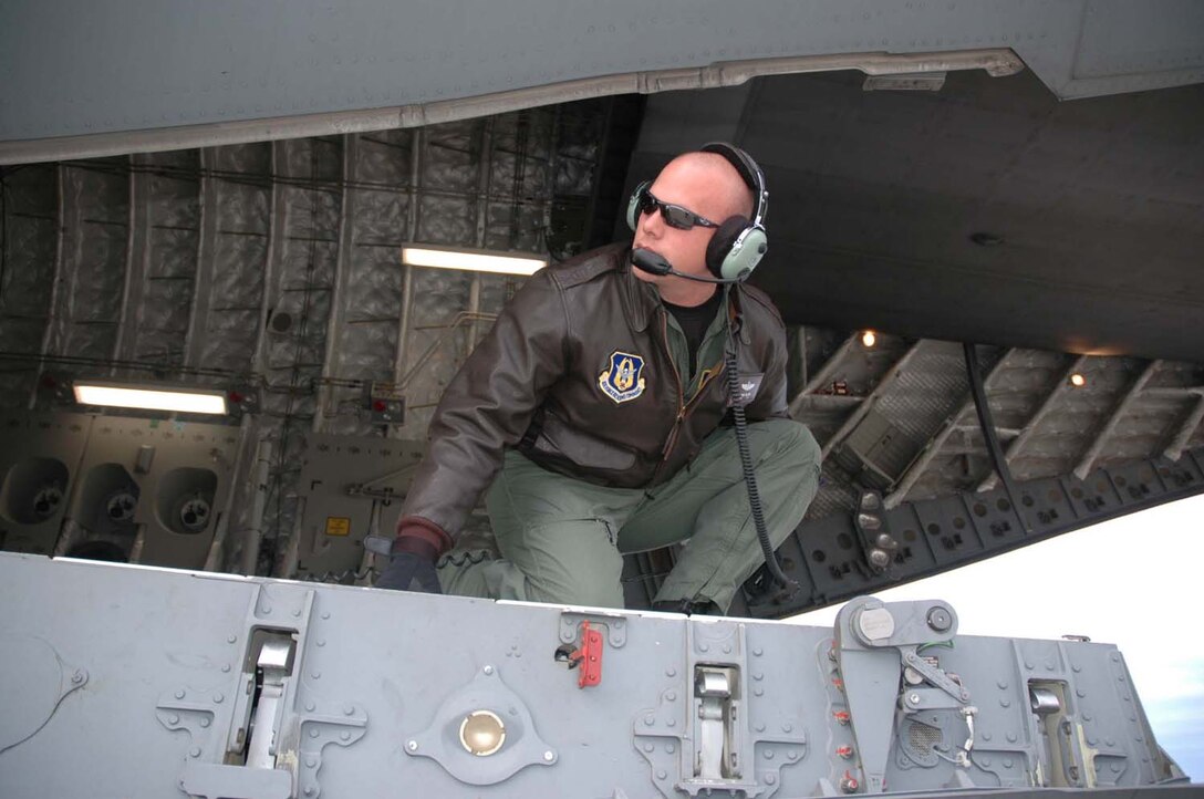 Staff Sergeant Mark Wilson, an Air Force Reserve loadmaster with the 728th Airlift Squadron, takes a look out the back of a C-17 at McChord Air Force Base, Wash.  Sergeant Wilson has 10 years of service in the Air Force Reserve. "The Air Force Reserve let's me serve my country with a flexible schedule," says Sergeant Wilson. He is one of more than 2,400 Citizen Airmen serving our nation with the 446th Airlift Wing at McChord.  (U.S. Air Force photo/Airman First Class Patrick Cabellon)