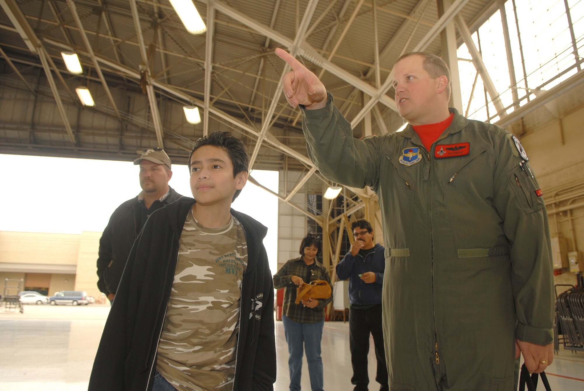 Maj. John Greven, 63rd Fighter Squadron, points out the fighter plane that pilot-for-a-day John "Buddy" Padilla Jr. will get to sit in on Dec. 12.