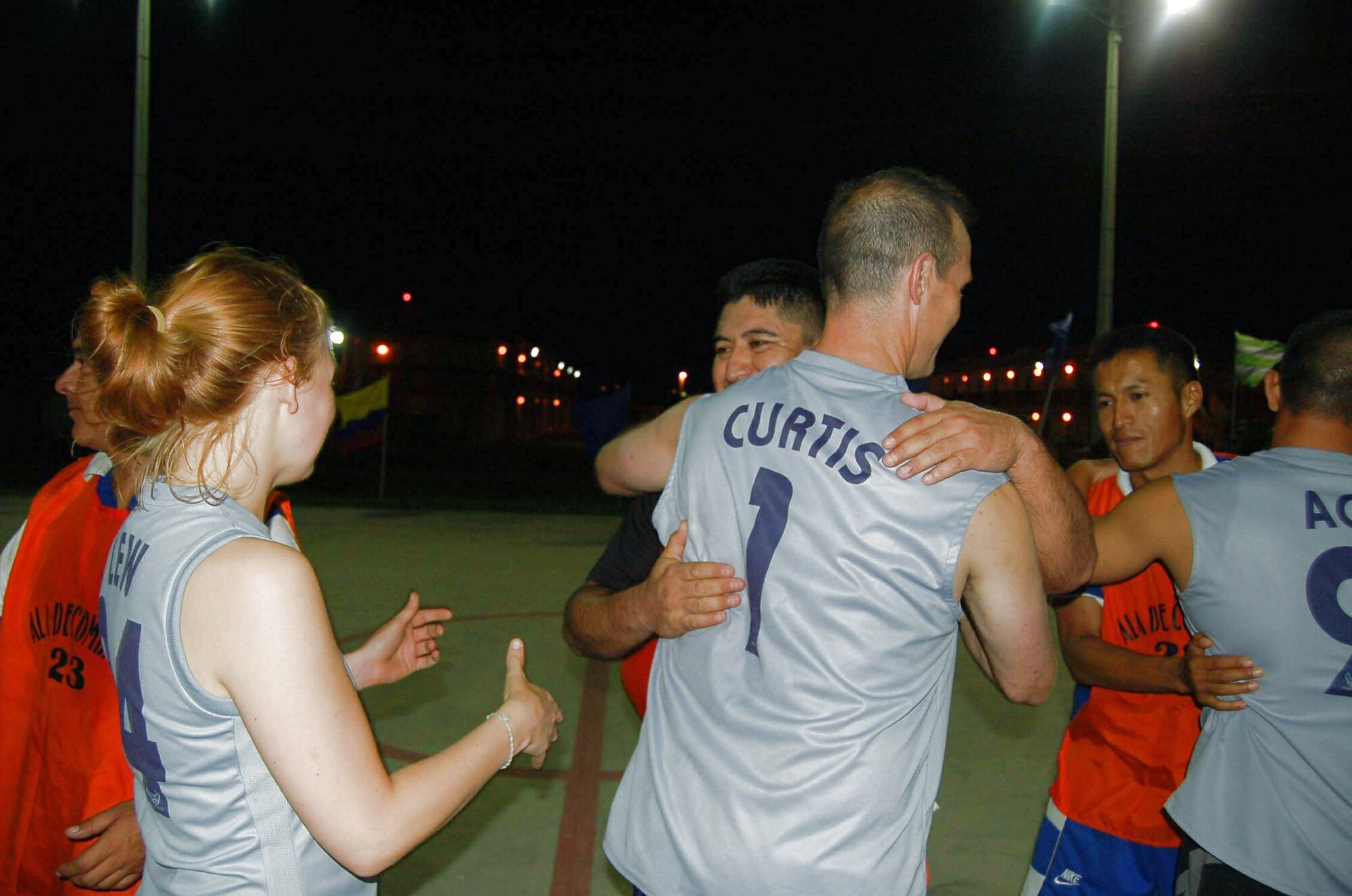 Members of the U.S. Air Force team hug the members of the Ecuadorian air force team after a championship basketball game Dec. 9 at Forward Operating Location Manta in Ecuador. Nearly 100 fans cheered on their favorite team, as the Ecuadorian air force pulled out a 26-25 victory. (U.S. Air Force photo/Tech. Sgt. Matthew McGovern) 
