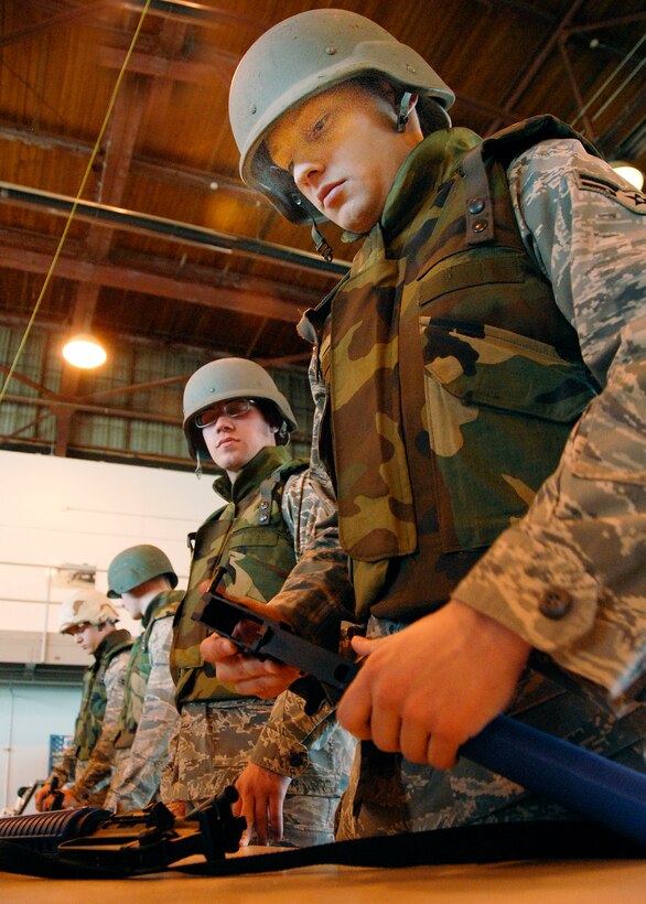 Crew chief student Airman Andrew Lynn watches fellow 362nd Training Squadron student Airman 1st Class Joshua Douglas put together his M-16 during a timed trial as part of Combat Skills Training Dec.12. The 362nd TRS implemented combat training into their Air Force specialties to prepare the future flight crew chiefs for deployments. (U.S. Air Force photo/Harry Tonemah)