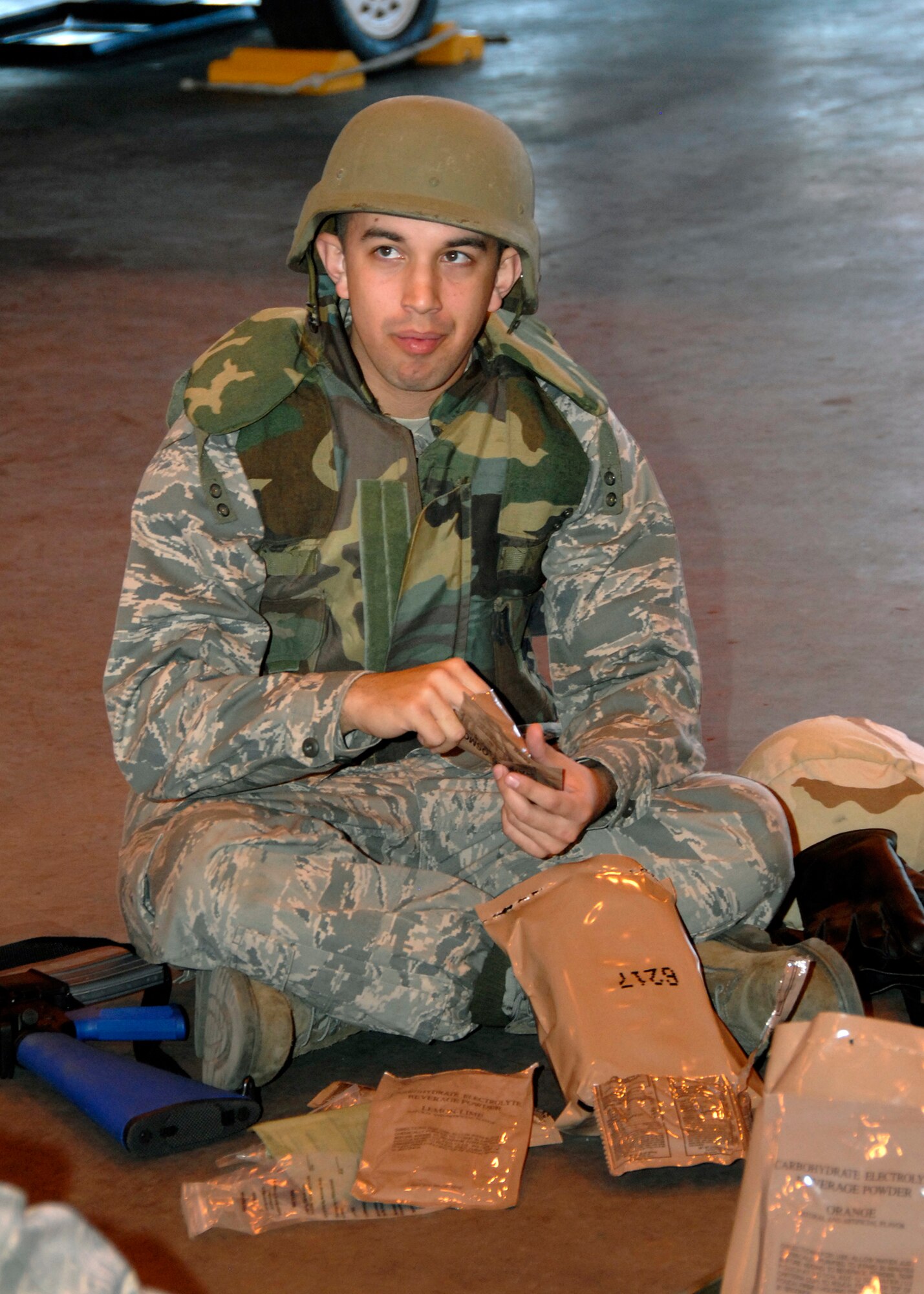 Airman Eugene Sollog, a 362nd Training Squadron student training to be an F-16 Crew Chief, eats his Meal Ready to Eat at lunch time during Combat Skills Training Dec.12. The 362nd TRS implemented combat training into their Air Force specialties to prepare the future flight crew chiefs for deployments. (U.S. Air Force photo/Harry Tonemah)