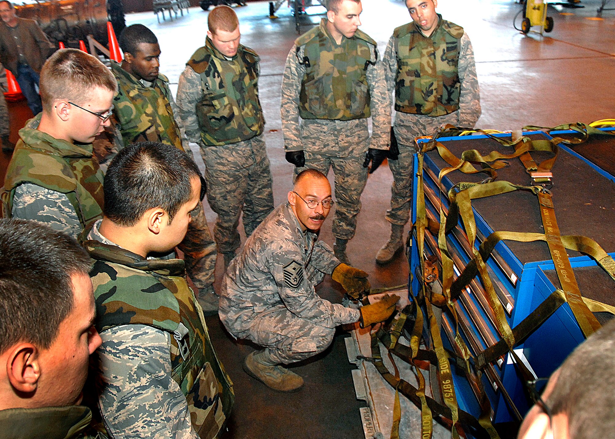 Master Sgt. Scotty Fogle demonstrates how to put on palette webbing to the troops during Combat Skills Training Dec.12. The 362nd TRS implemented combat training into their Air Force specialties to prepare the future flight crew chiefs for deployments. (U.S. Air Force photo/Harry Tonemah)