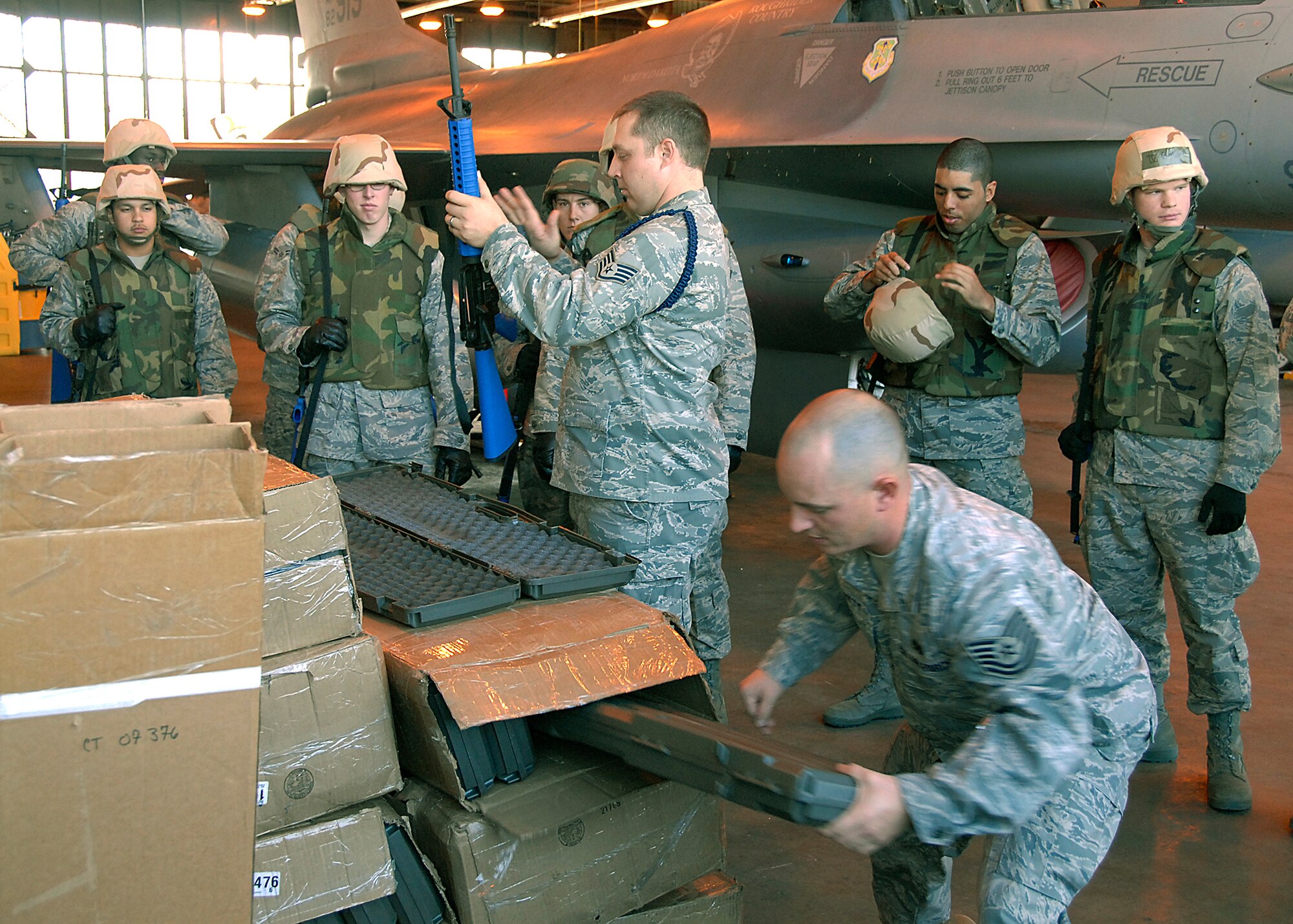 Staff Sgt. Darren Sayler and Tech. Sgt. Chad Everett, organizers for the 362nd Training Squadron combat training, hand out Training M-16 rifles to troops that were going through the Combat Skills Training Dec.12. The 362nd TRS implemented combat training into their Air Force specialties to prepare the future flight crew chiefs for deployments. (U.S. Air Force photo/Harry Tonemah)