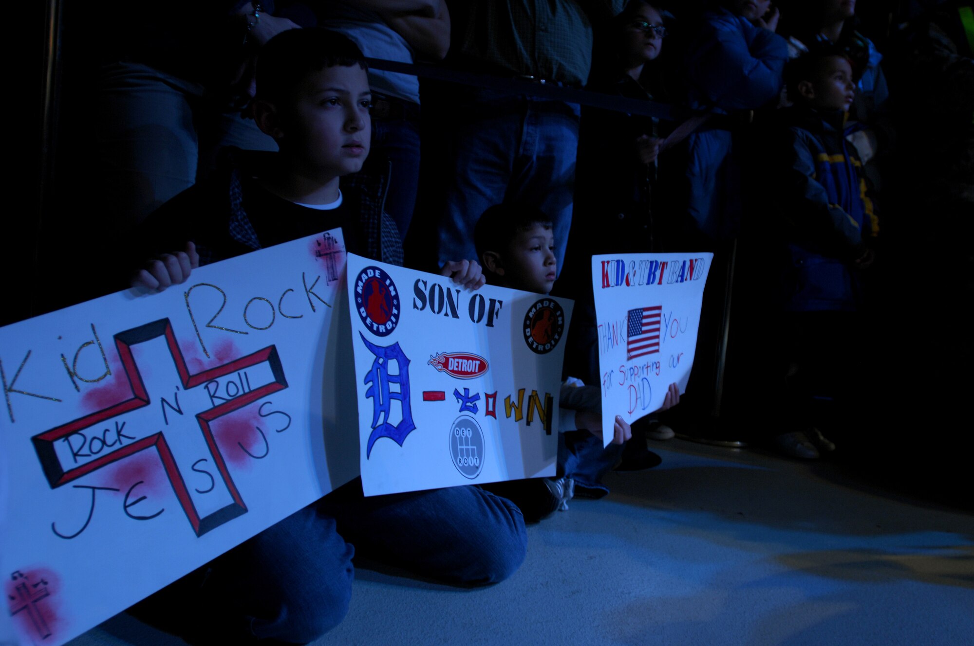 Children hold signs for their favorite performer during the United Service Organizations (USO) Holiday Tour stop in Hanger 1 at Ramstein Air Base, Germany, Dec. 16, 2008. Some of the performers included Lewis Black and Kid Rock. (U.S. Air Force photo Airman 1st Class Kenny Holston)