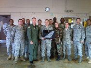 Col William B. Binger, 482nd Fighter Wing commander presents the 2008 Air Force Reserve Command Fully Mission Capable Award to the 482nd Maintenance Squadron AGE Flight on Dec. 6. Also pictured are: Col. Melvin J. Giddings, second from the right, 482nd Maintenance Group commander and Chief Master Sgt. Fred D. Hennagan, far right, 482nd Maintenance Squadron superintendent. The AGE flight maintains 96 pieces of powered equipment; 72 pieces of rolling stock and 37         non-deployable pieces of equipment required to support 26 F-16 fighter aircraft, transit alert and munitions storage operations. (U.S. Air Force photo/Chief Master Sgt. Katdo Robinson)