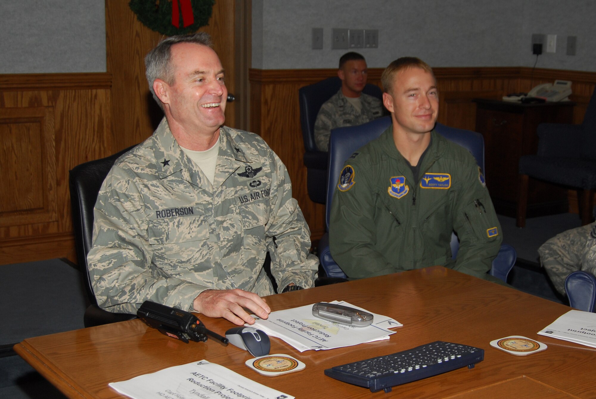Capt. Scott Taylor, 95th Fighter Squadron C Flight commander, shadows Brig. Gen. Darryl Roberson, 325th Fighter Wing commander, during the staff meeting here today.  Captain Taylor oversees training of 20 student pilots annually under eight formal syllabi, preparing them for air dominance mission.  He also mentored eight above-average students through extensive, re-qualifying program after the F-15 grounding.  Captain Taylor spent the day with General Roberson as part of the Commander’s Shadow Program.  He has served over eight years in the military and is a native of Newberg, Ore.  (U.S. Air Force photo by Lisa Norman)  